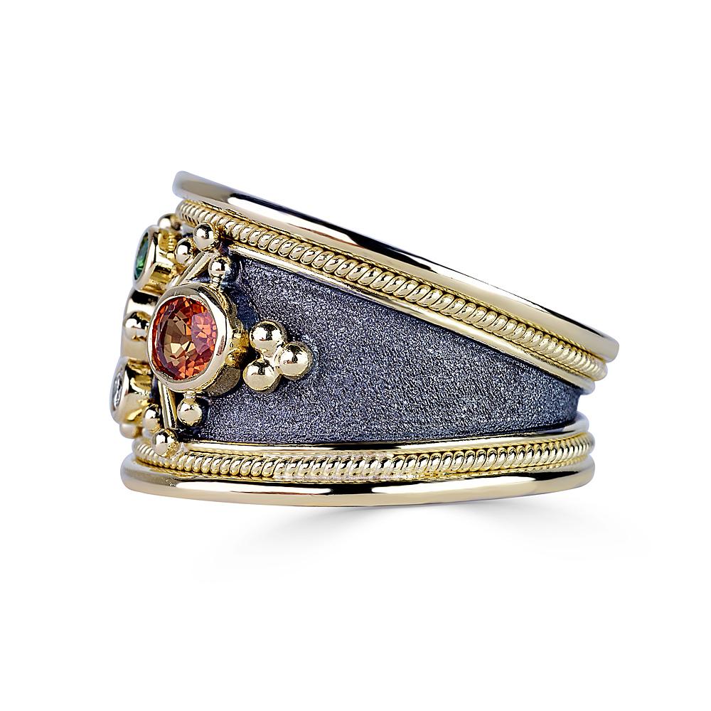 S.Georgios designer Multi Sapphire ring all handmade from solid 18 Karat White Gold. The gorgeous ring is microscopically decorated all the way around with Yellow Gold Decorations. Granulated details contrast with Byzantine velvet background