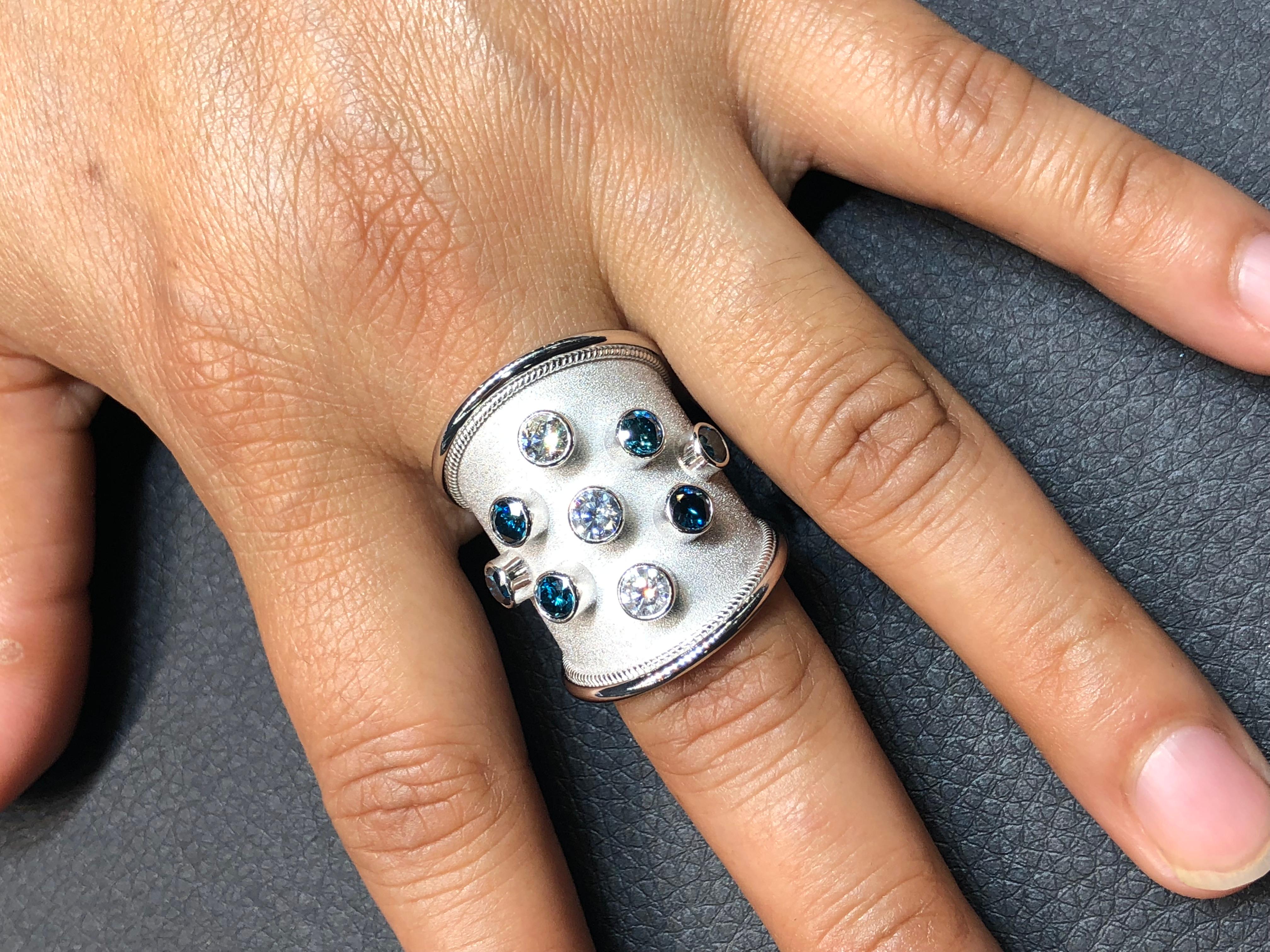 S.Georgios designer 18 Karat White Gold Thick Band Ring all handmade with Byzantine workmanship and a gorgeous velvet background done all under a microscope. The beautiful ring features 6 Brilliant cut Blue Diamonds total weight of 1.32 Carat and 3