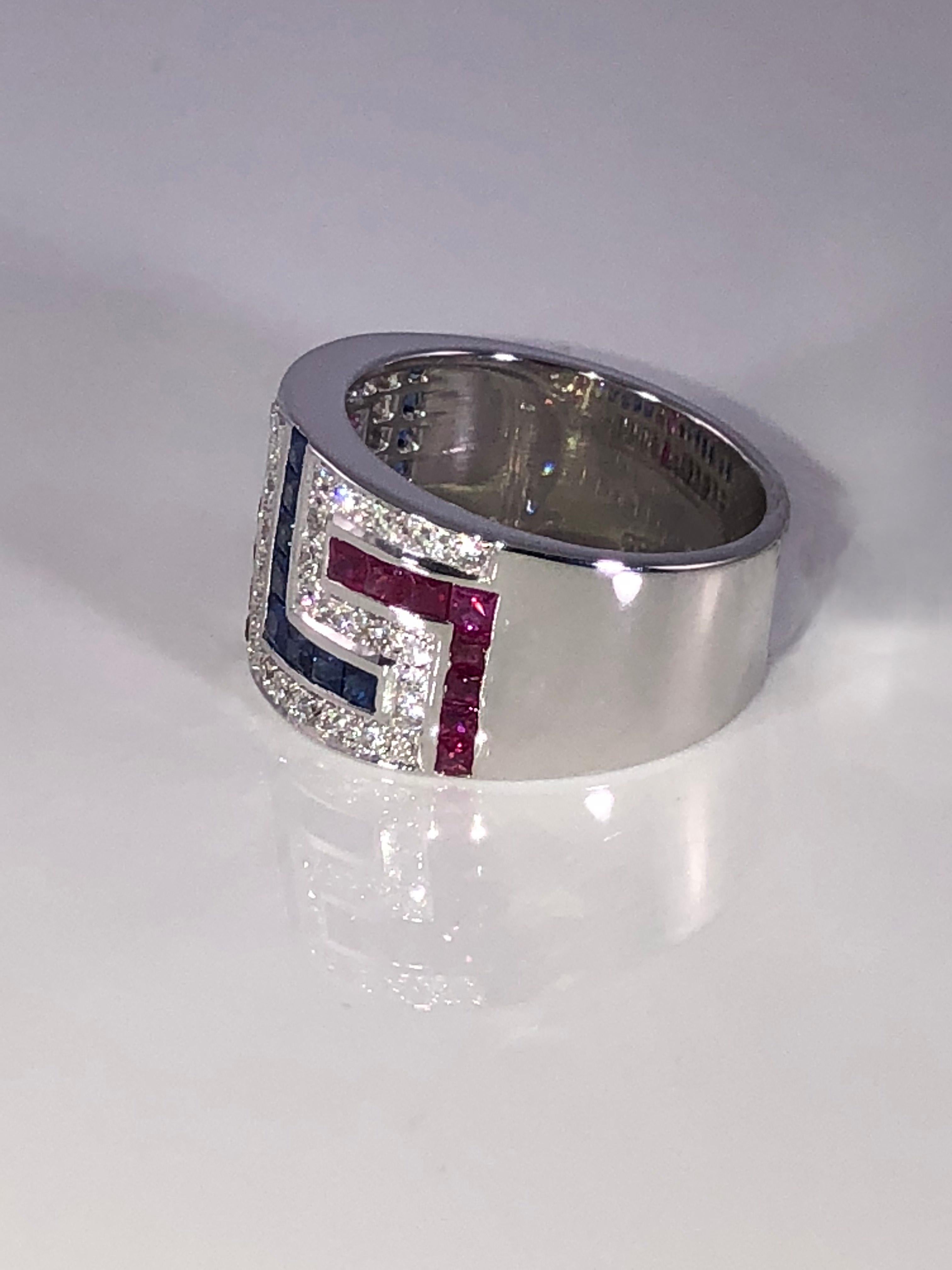 S.Georgios designer 18 Karat White Gold Ring featuring the Greek Key design symbolizing eternity all custom-made. It has Brilliant Cut White Diamonds total weight of 0.46 Carat, Princess cut Rubys total weight of 0.90 Carat and Sapphires total