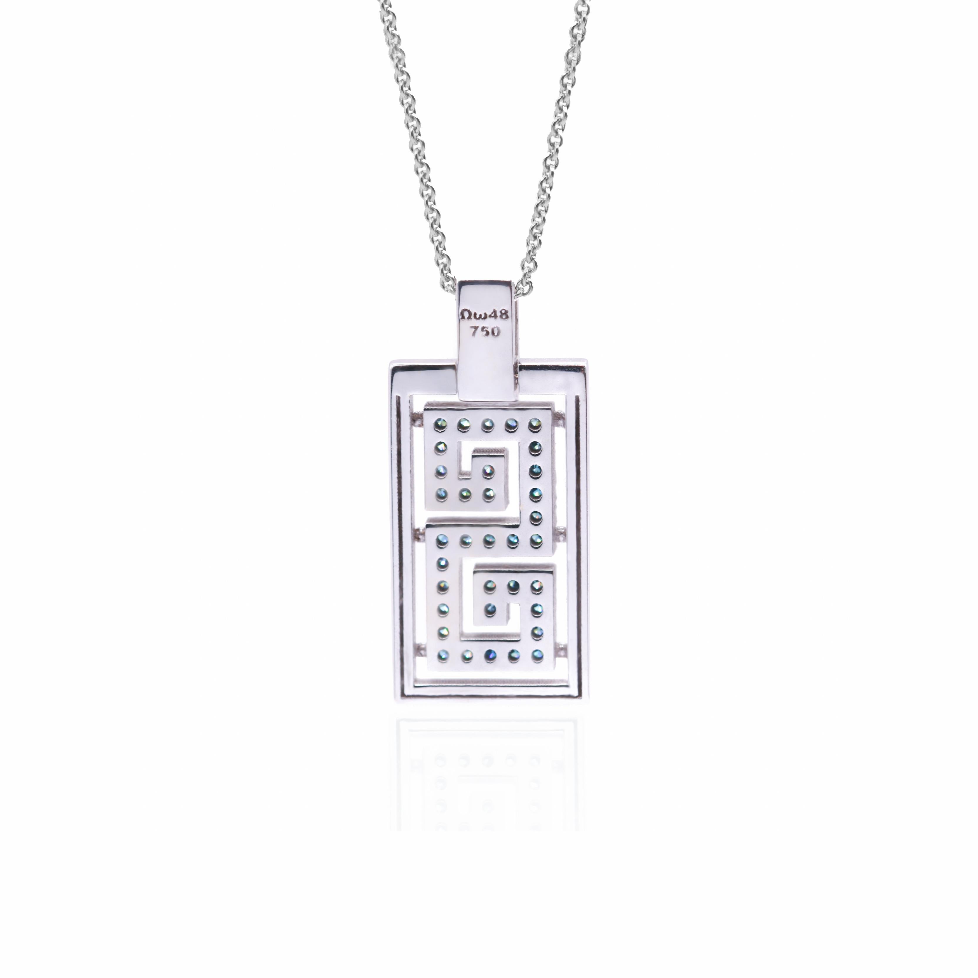 Il pendente di design S.Georgios è realizzato a mano in oro massiccio S.S. White da 18 carati e scolpito in un moderno design a chiave greca, che simboleggia l'eternità e l'unità. Questo elegante pendente è impreziosito da diamanti bianchi a taglio