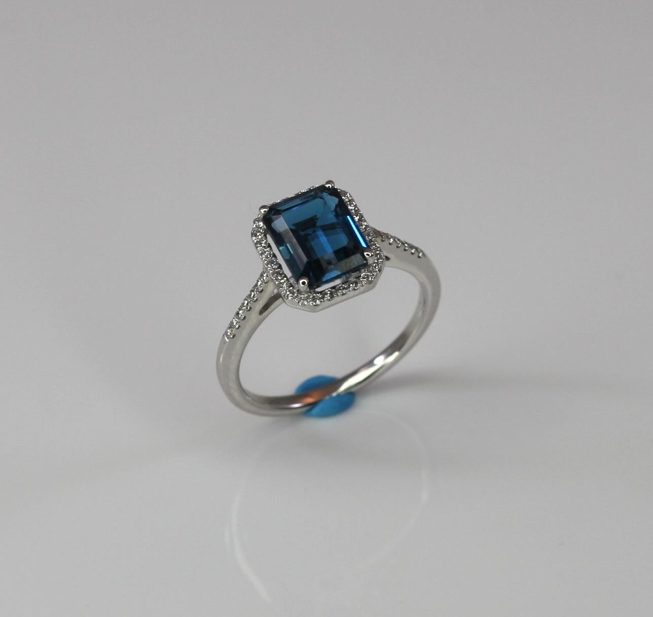 S. Georgios designer London Blue Topaz solitaire white gold 18 karat ring is all handmade and features a 3.44 Carat London Blue Topaz emerald cut, accompanied by Brilliant-cut White Diamonds, the total weight of 0.22 Carat. This is a gorgeous