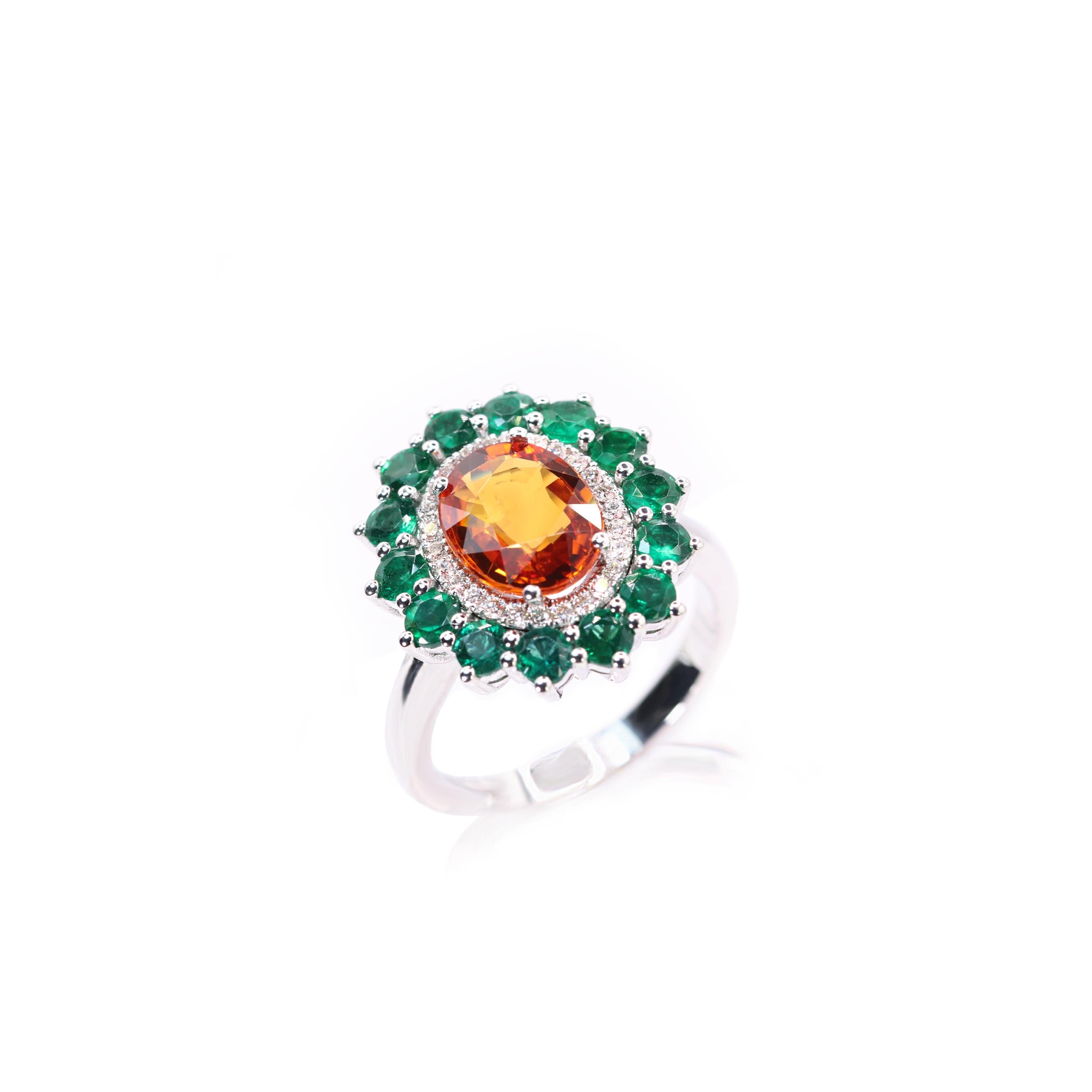 S.Georgios designer presents a stunning 18K White Gold Ring in a floral design. At the center of the flower is a vivid oval 2,85 Carats Orange Sapphire, surrounded by brilliant-cut Diamonds total weigjt of 0,21 Carats. The petals are composed of