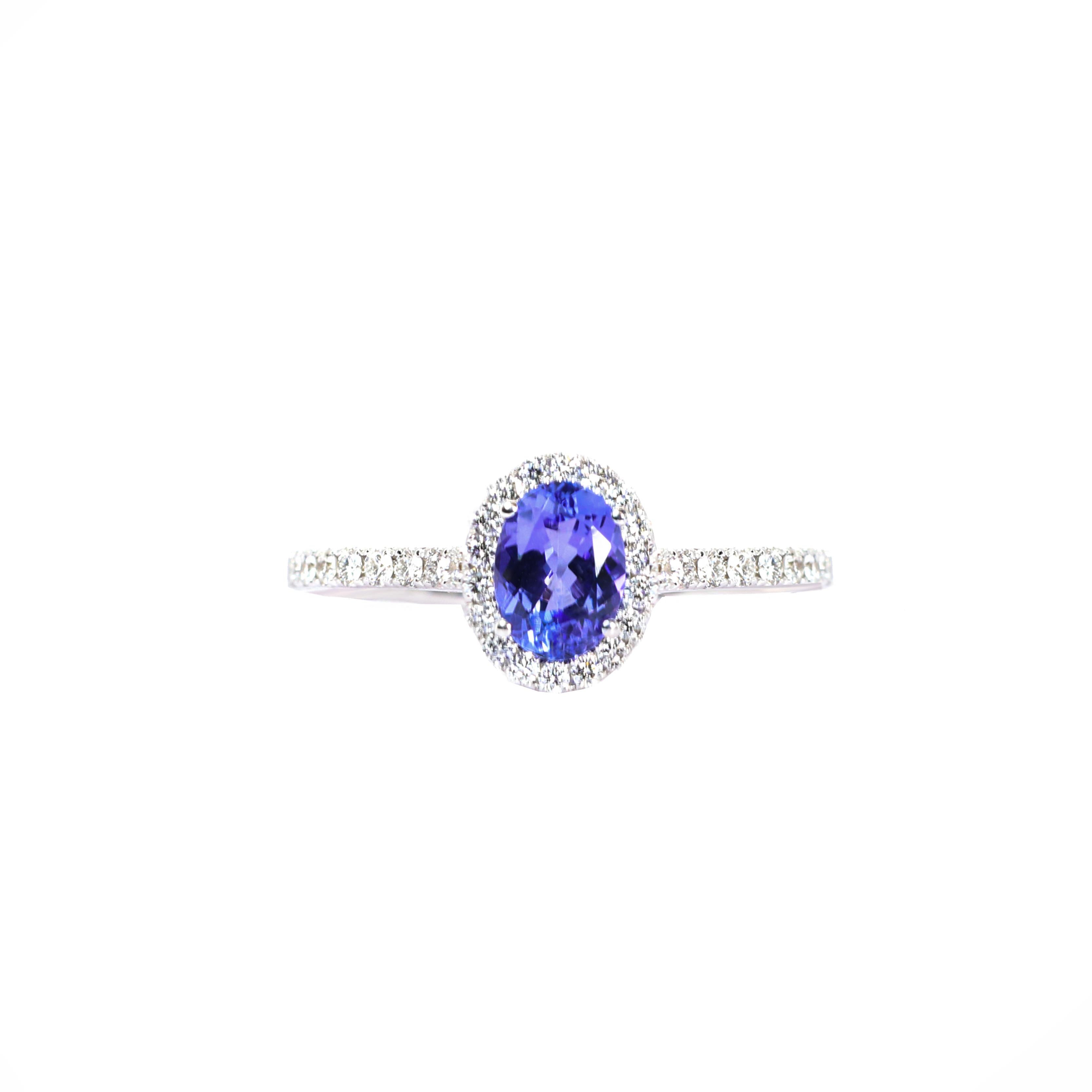 S.Georgios designer presents an exquisite 18 Karat White Gold Ring featuring an oval-cut 1.27 Carats Tanzanite at its center, framed by a dazzling bezel of White Diamonds, total weight of 0.30 Carats. The Tanzanite boasts a rich, vibrant blue hue
