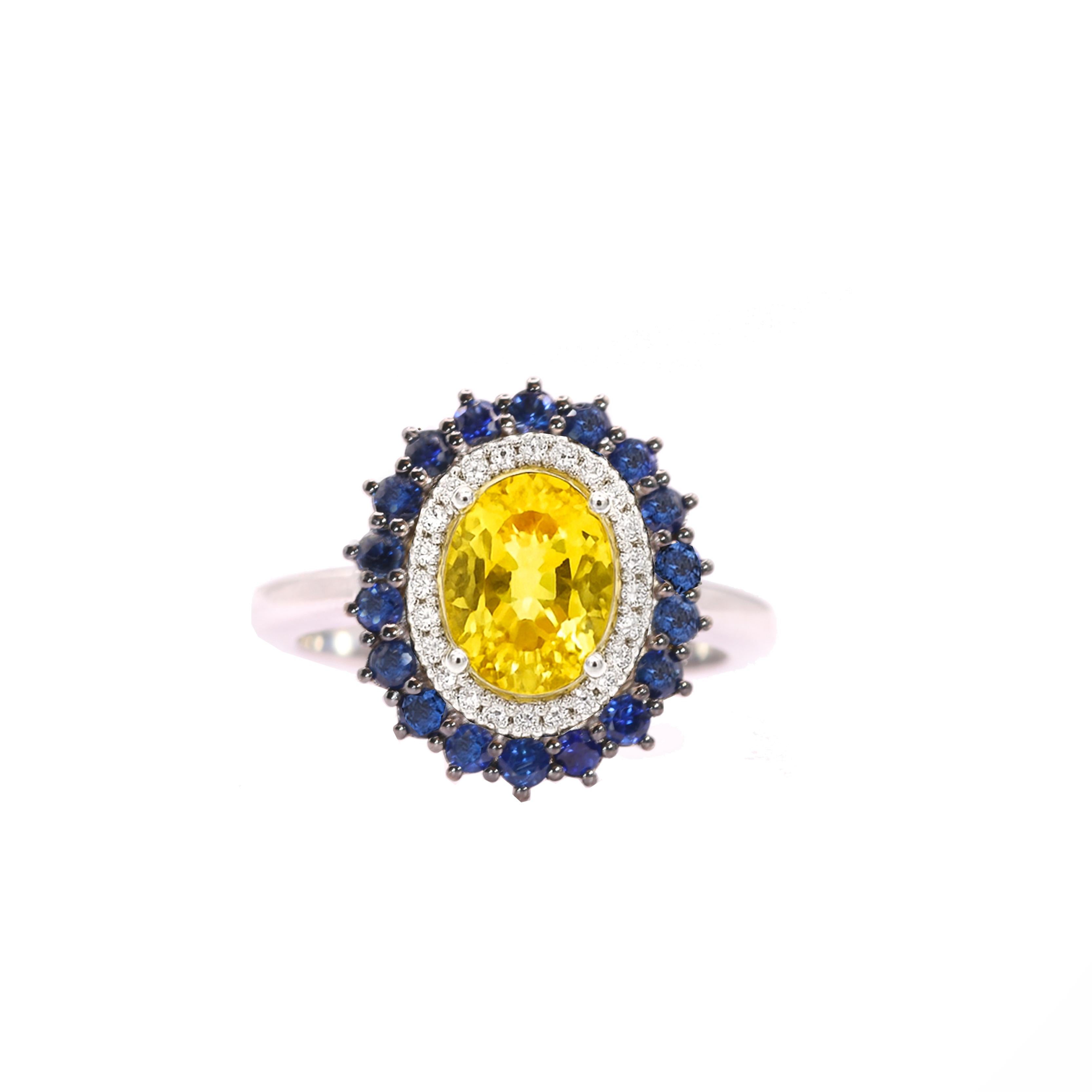 S.Georgios designer presents an exquisite 18K White Gold Ring featuring an oval cut 1,87 Carats Yellow Sapphire at its center. This vibrant gemstone is elegantly surrounded by white brilliant cut diamonds, total weight of 0,14 carats and deep blue