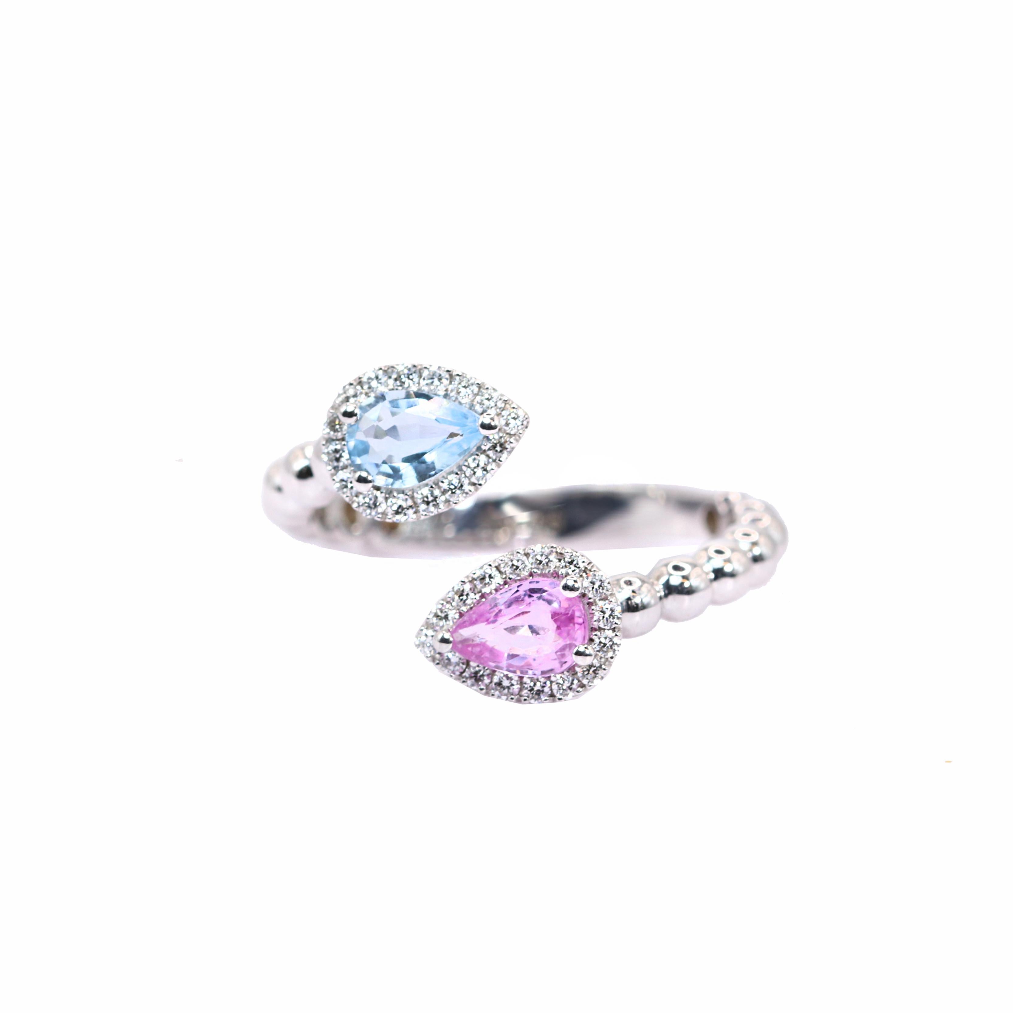 S.Georgios designer presents an exquisite 18K White Gold Ring featuring one pear-cut 0,26 Carats Aquamarine Gemstone and one 0,44 Carates Pink Sapphire. The light blue and pink pear cut gemstones are also sourounded by brilliant cut Diamonds total