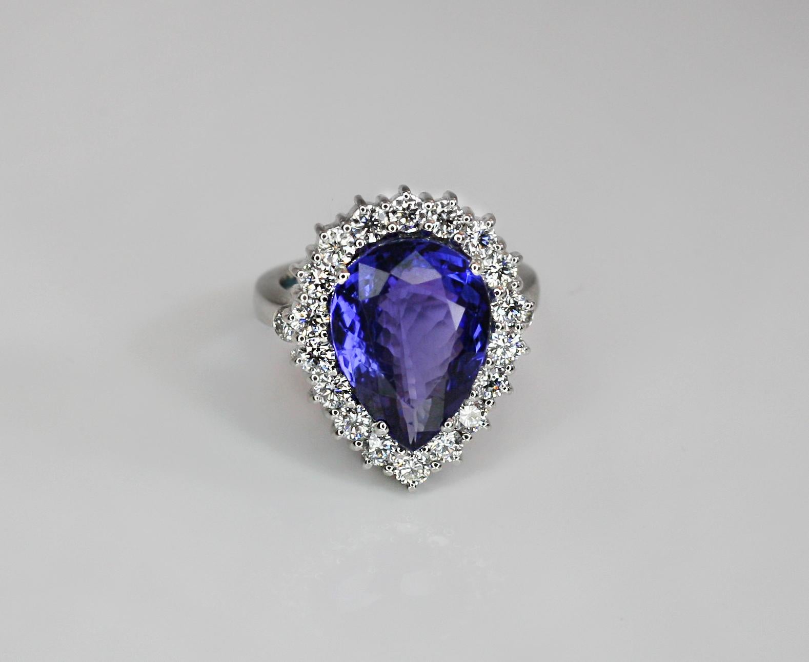 S.Georgios designer Ring is all hand-made in 18 Karat White Gold and features a stunning color, pear cut natural Tanzanite total weight 8.40 Carat surrounded by natural VVS2 color F white brilliant-cut Diamonds total weight of 1.49 Carat. This is a