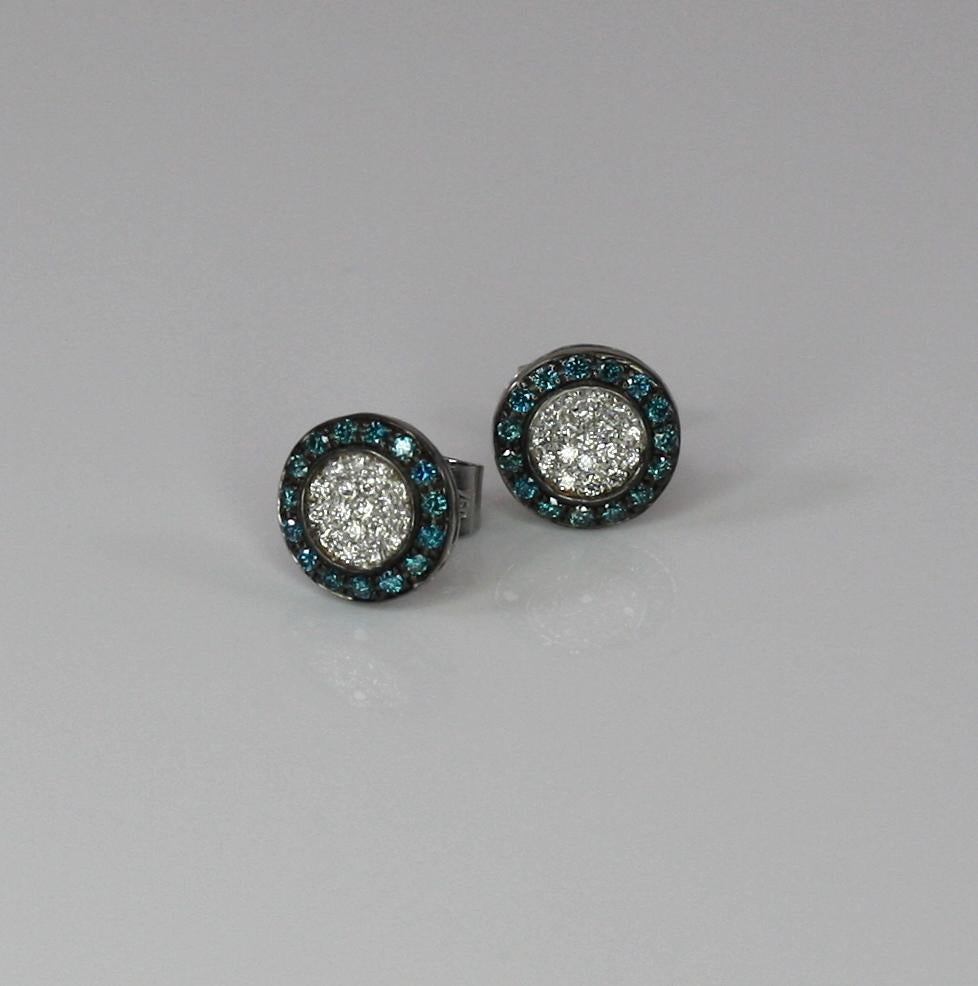 S.Georgios designer Earrings are 18 Karat White Gold and all handmade. They feature white brilliant cut diamonds total weight of 0.29 Carat and blue diamonds total weight of 0.34 Carat. The prongs that hold the blue diamonds are with black Rhodium