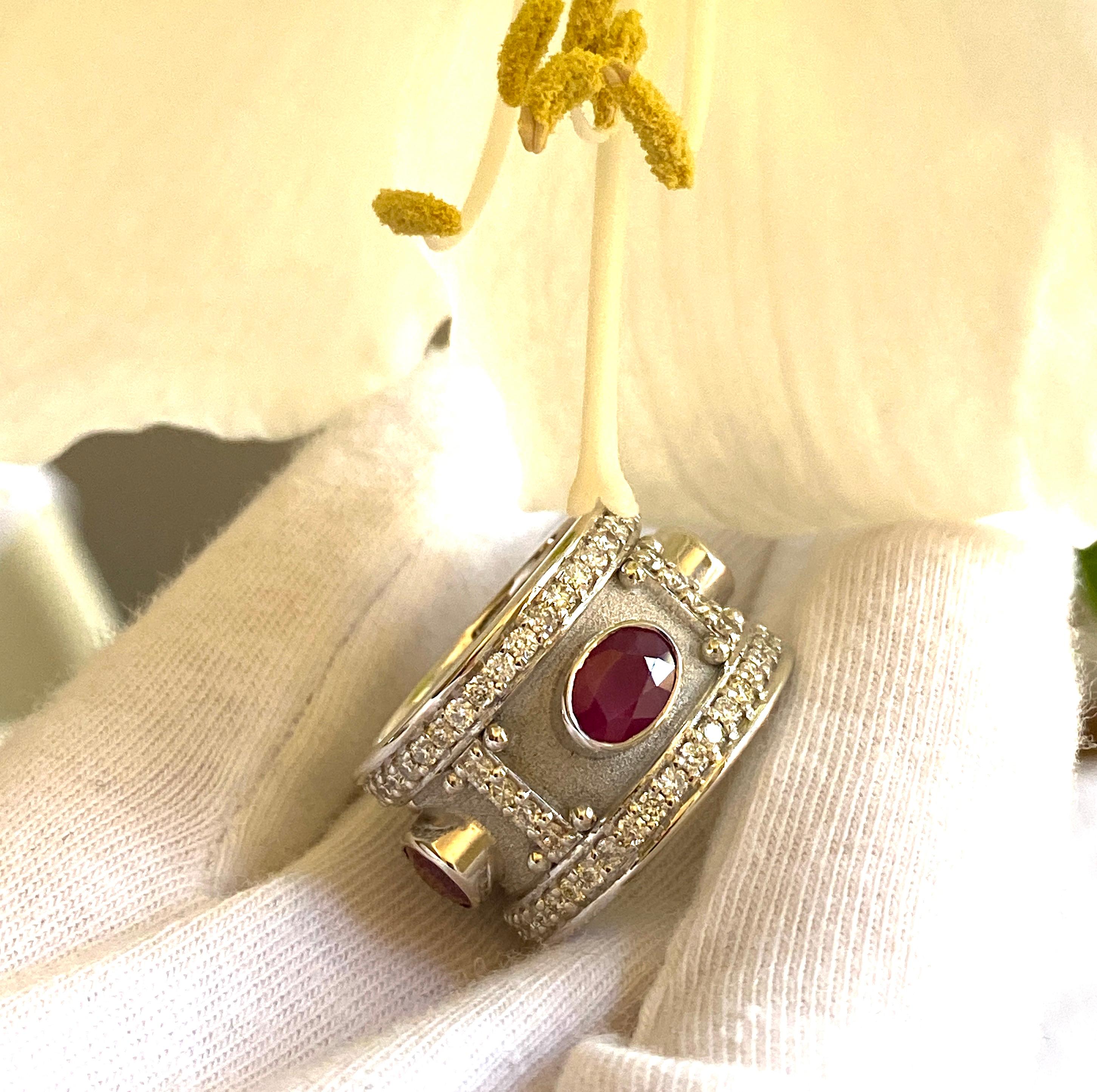 The is gorgeous S.Georgios designer 18 Karat Solid White Gold Wide Band Ring all handmade in Greece in the elegant look inspired by Byzantine era. Ring is heavily decorated with granulation details and features 4 oval cut Rubies in total weight of