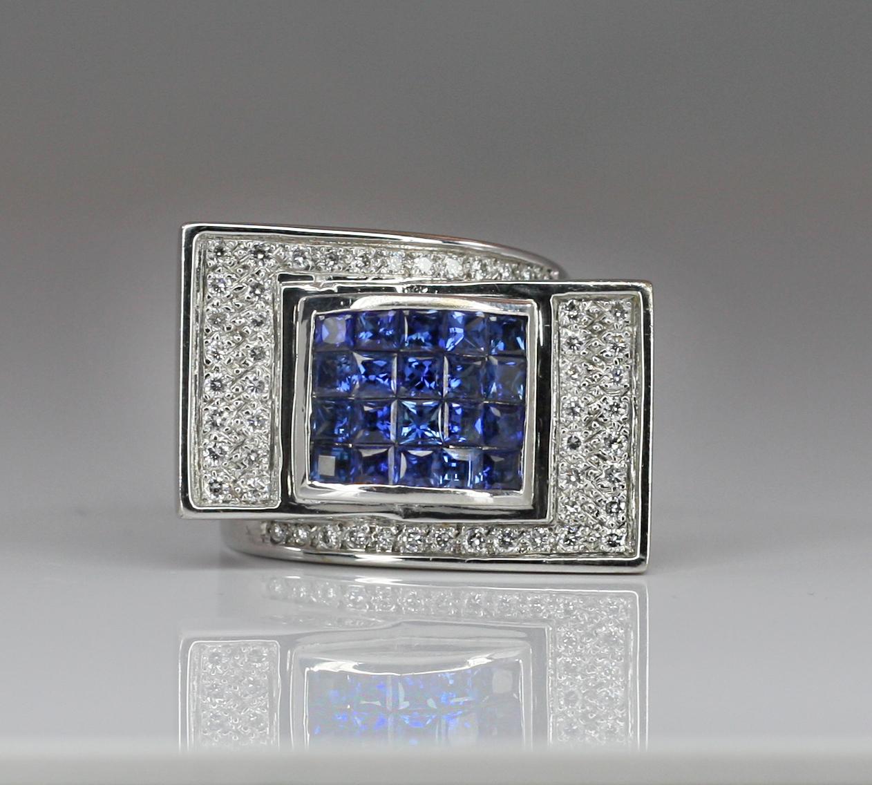 This S.Georgios designer Ring is all hand-made and heavy 18 Karat White Gold Wide Band. The gorgeous piece features 20 stunning Princess cut natural blue Sapphires total weight 2.49 Carat set in an invisible setting, and surrounded by natural