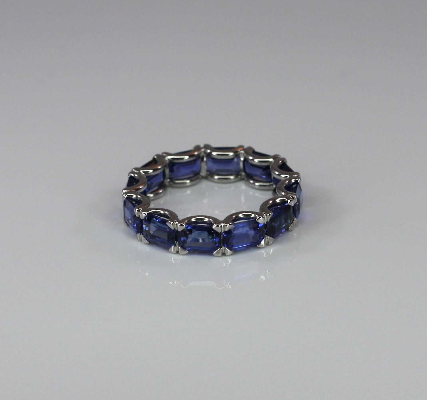 S.Georgios designer eternity sapphire band ring is handmade from 18 Karat white gold in Athens Greece. This gorgeous band ring features 8.72 Carat emerald cut Natural Blue Sapphires in a beautiful setting.
All Georgios Collections jewelry is