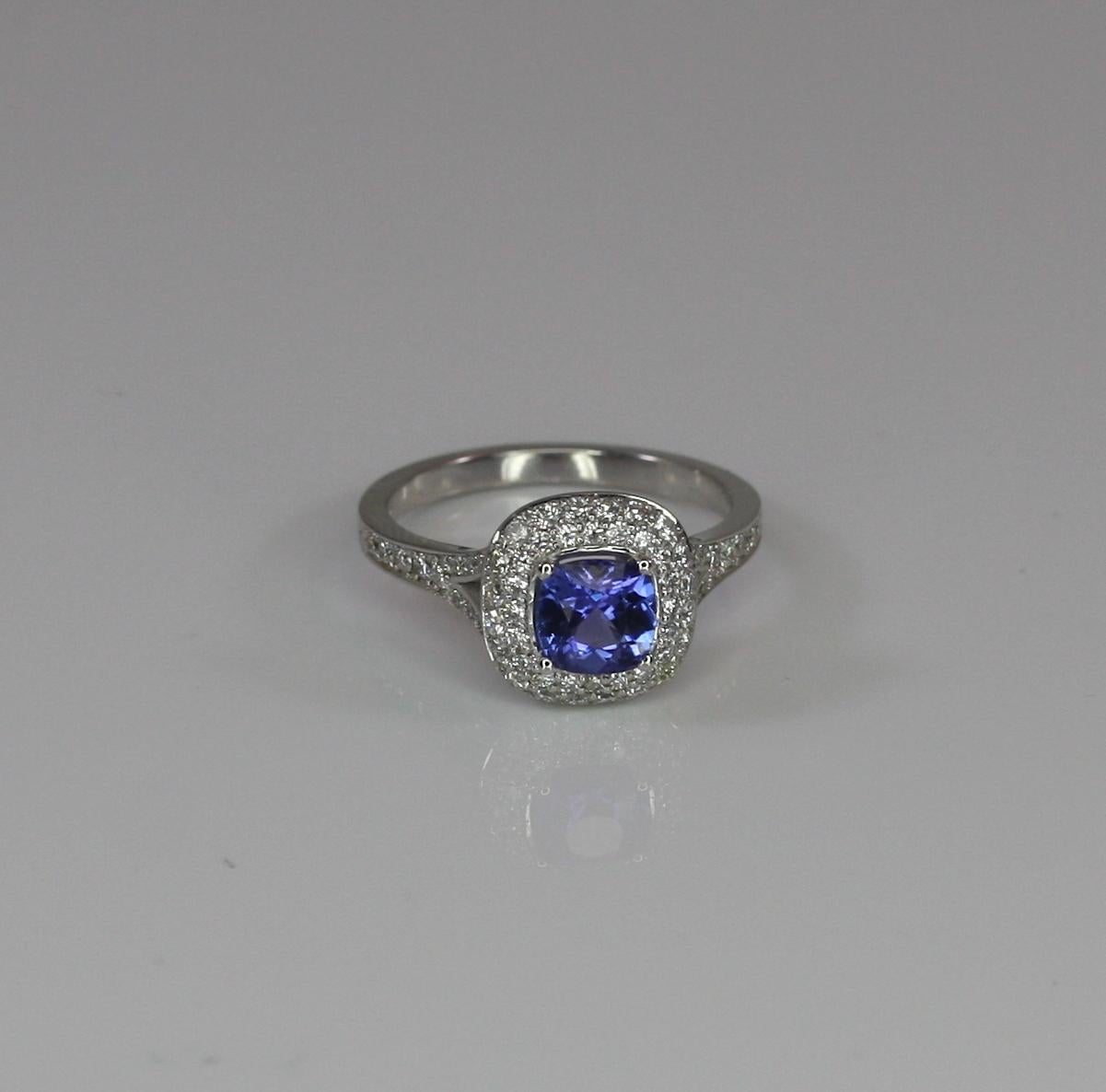 This S.Georgios designer White Gold 18 Karat ring features an exquisite 0.89 Carat cushion cut Tanzanite accompanied by Brilliant-cut White Diamonds a total weight of 0.60 Carat. This classic and elegant gorgeous ring is for everyday wear and is