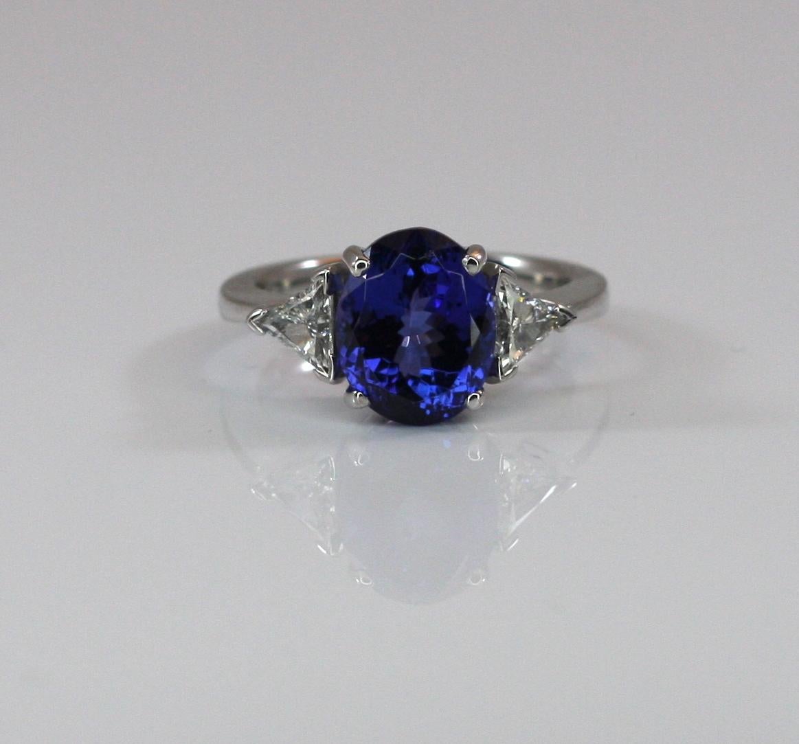 S. Georgios designer Ring in White Gold 18 Karat all hand made featuring an Oval cut natural Tanzanite the weight 5.22 Carat and two (2) natural white diamonds trilliant cut total weight of 0.44 Carat. This is a gorgeous and classic ring for every