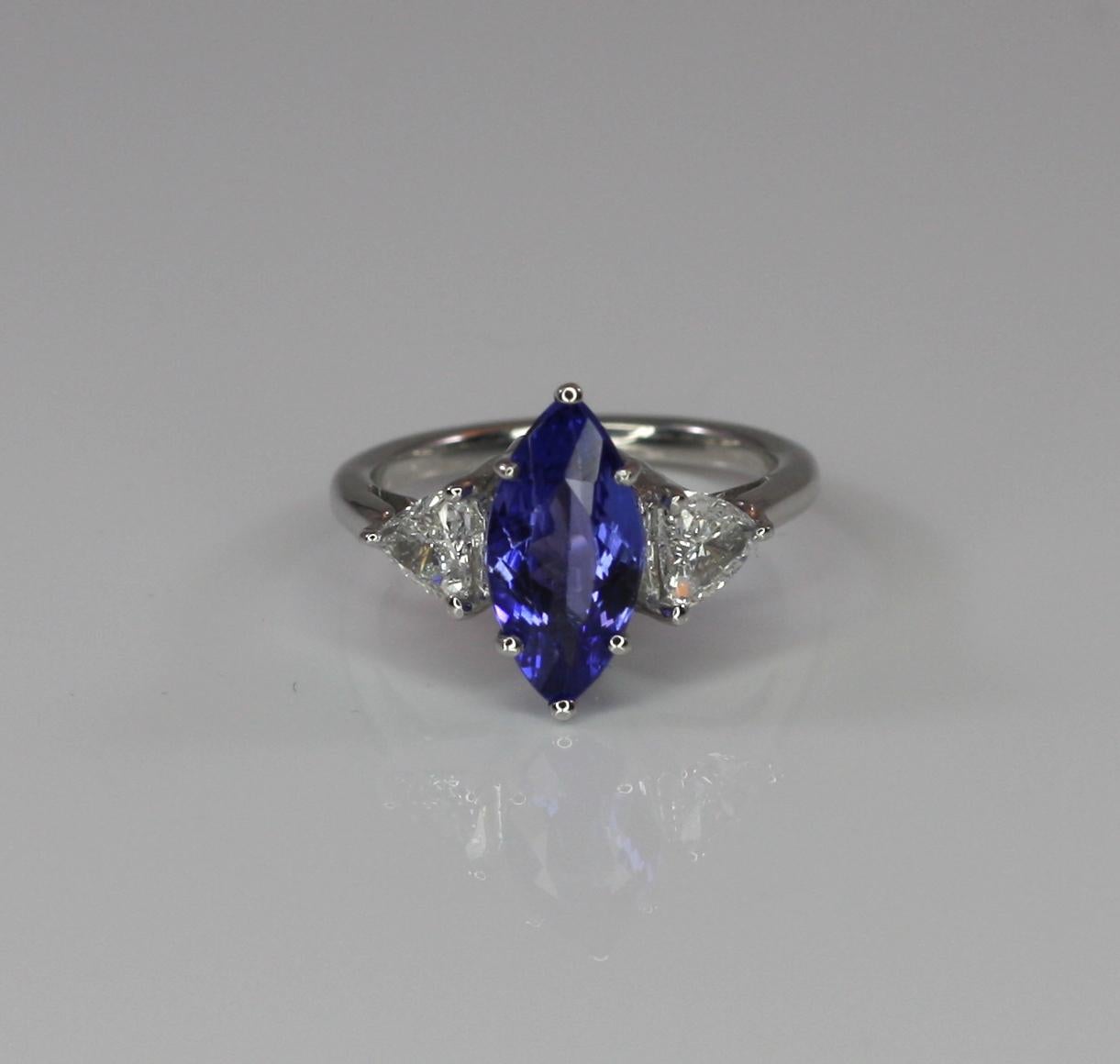 S. Georgios designer Ring in White Gold 18 Karat all hand made featuring a solitaire Marquise cut Tanzanite the weight 2.14 Carat and two (2) natural white diamonds trilliant cut total weight of 0.66 Carat. This is a gorgeous and classic ring for
