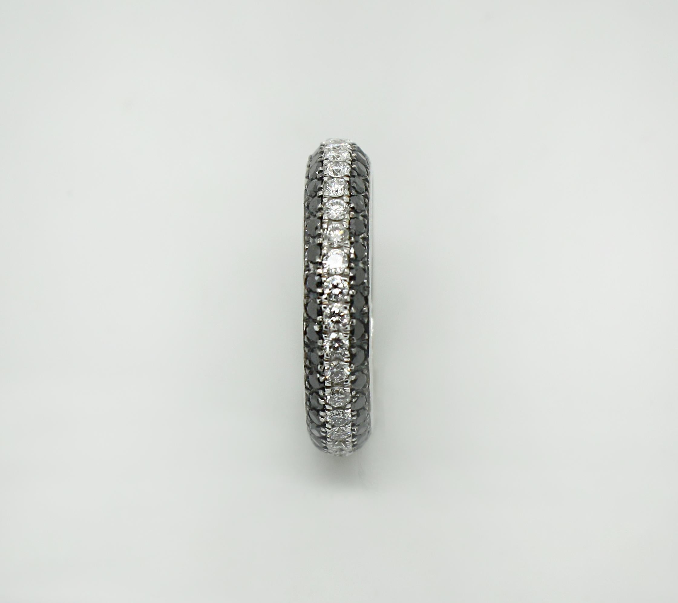 This S.Georgios designer 18 Karat White Gold Band Ring is all handmade in a unique two-tone look. The gorgeous band features brilliant cut white diamonds total weight of 0.78 Carat, and black diamonds total weight of 1.10 Carat which are set in