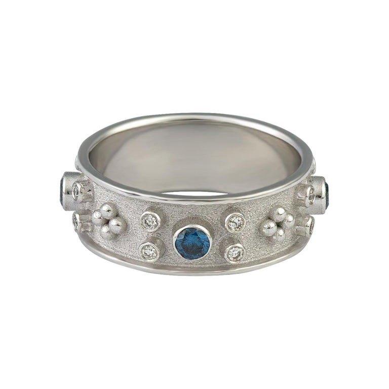 S.Georgios designer 18 Karat Solid White Gold Band Ring all handmade with Byzantine granulation workmanship and a unique velvet background. The stunning ring has 4 brilliant cuts of Blue Diamonds with a total weight of 0.48 Carats and 16