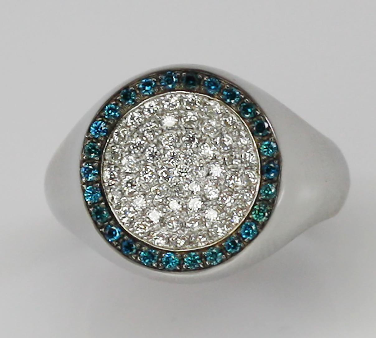 This S.Georgios designer Men's Unisex Band Ring is all hand-made in 18 Karat White Gold and features an orb of stunning brilliant cut natural white Diamonds total weight 0.88 Carat. Encircled we have set in black Rhodium prongs 26 brilliant-cut Blue