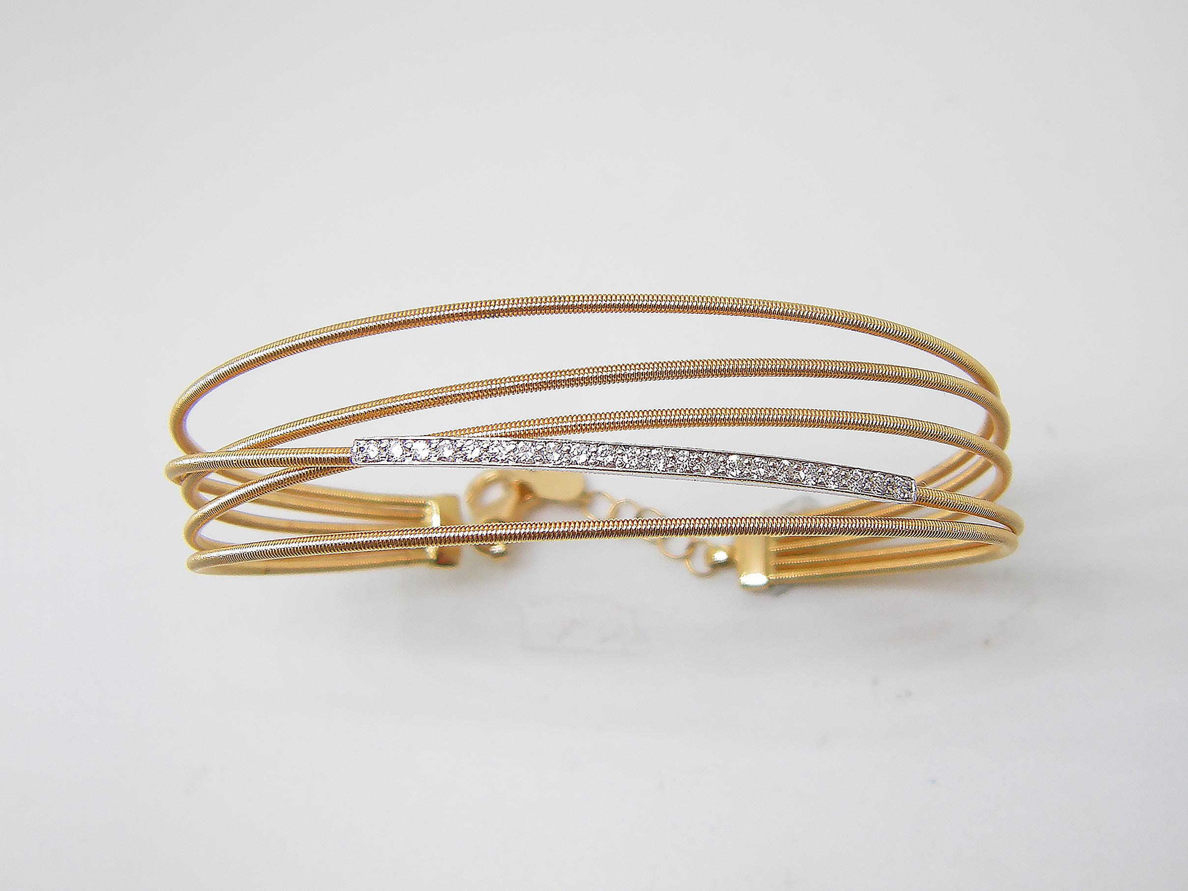 S.Georgios designer flexible multi layers bangle cuff bracelet is custom made of Yellow and White gold 18 karats. The gorgeous cuff has brilliant cut white diamonds total weight of 0.30 Carat set microscopically.
We also make this stunning piece in