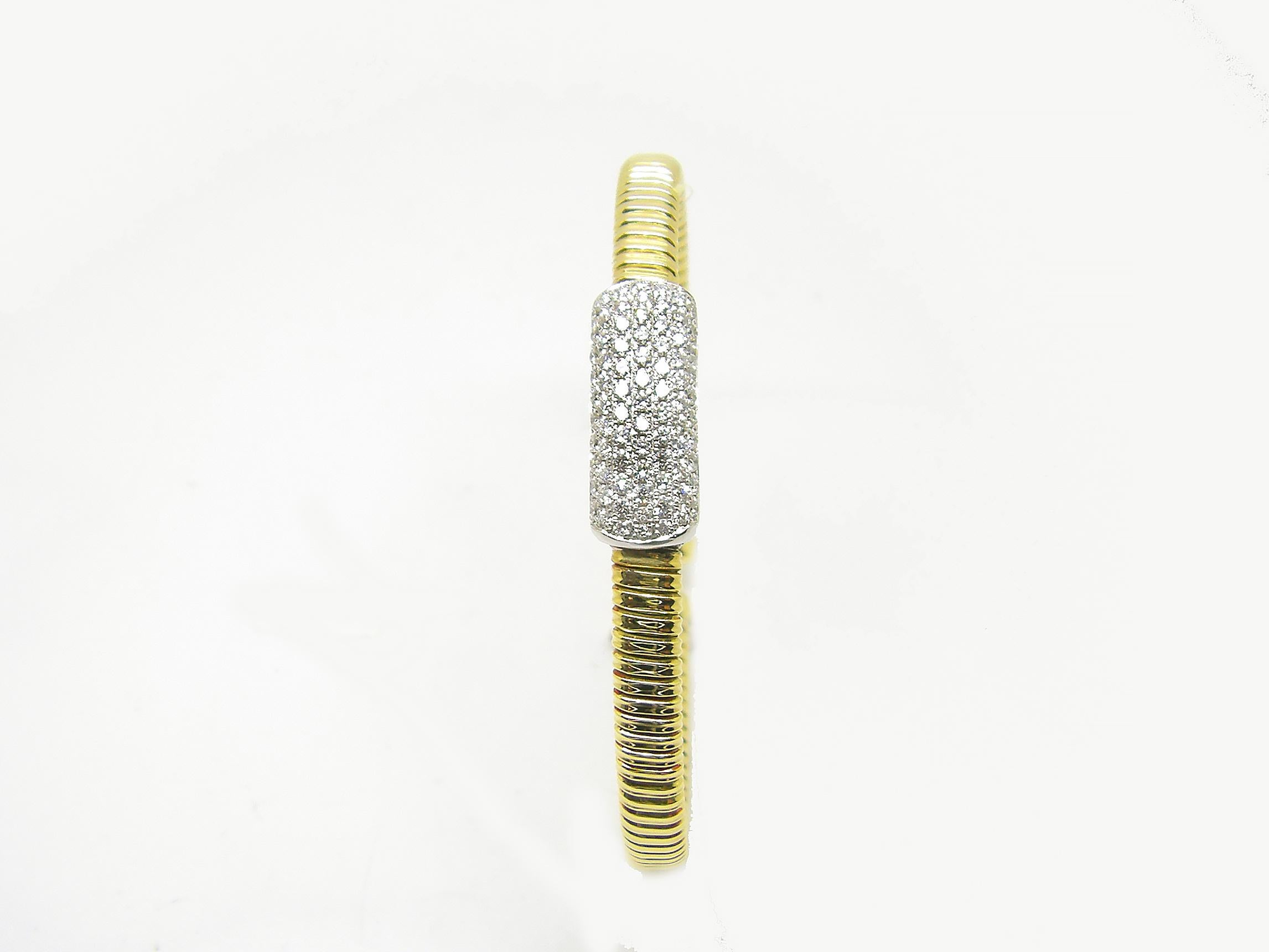 S.Georgios designer thin bangle cuff bracelet is custom made of Yellow and White gold 18 karats. The gorgeous cuff has brilliant cut white diamonds total weight of 0.80 Carat set microscopically on a white gold bar and is all made with twisted wires