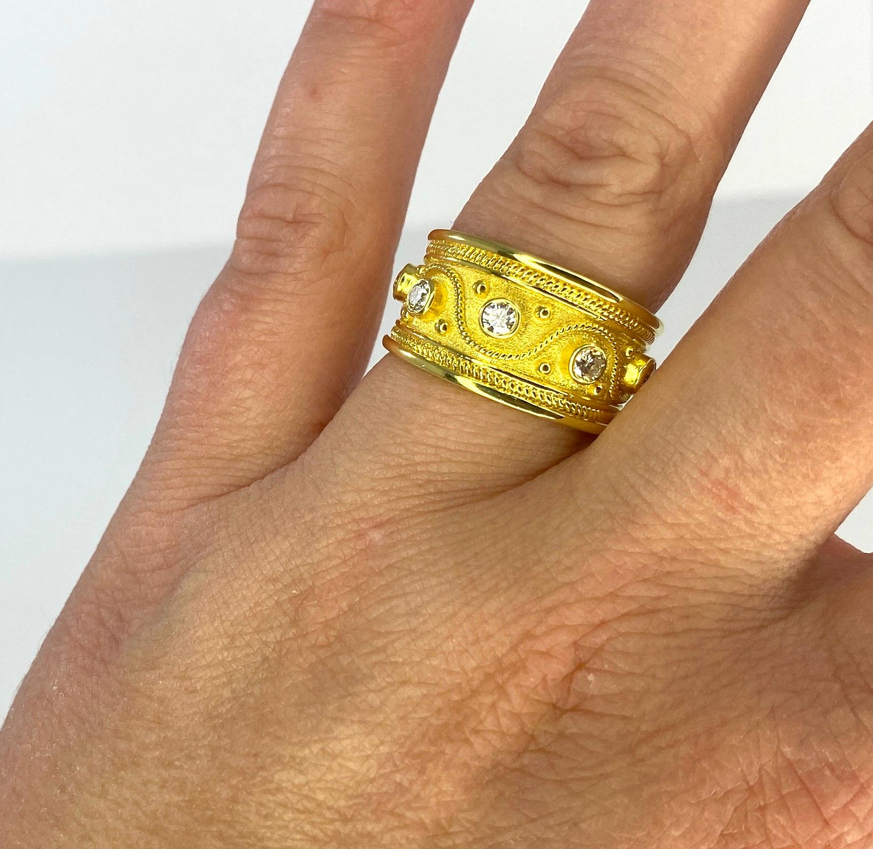 S.Georgios designer graduated ring handmade from solid 18 Karat Yellow Gold. The ring is microscopically decorated with 18 Karat yellow gold beads that are set separately and twisted wire that is invisibly connected and turns and twists all the way