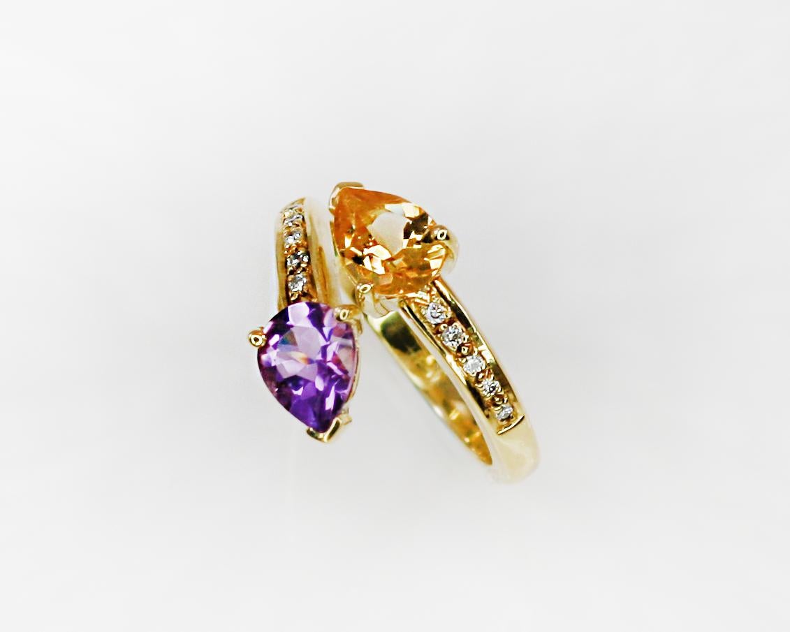 This S.Georgios designer Ring is all hand-made in yellow Gold 18 Karat. It features a solitaire teardrop cut natural Citrine and teardrop natural Amethyst with a total weight of 1.80 Carat and natural white brilliant cut diamonds total weight of