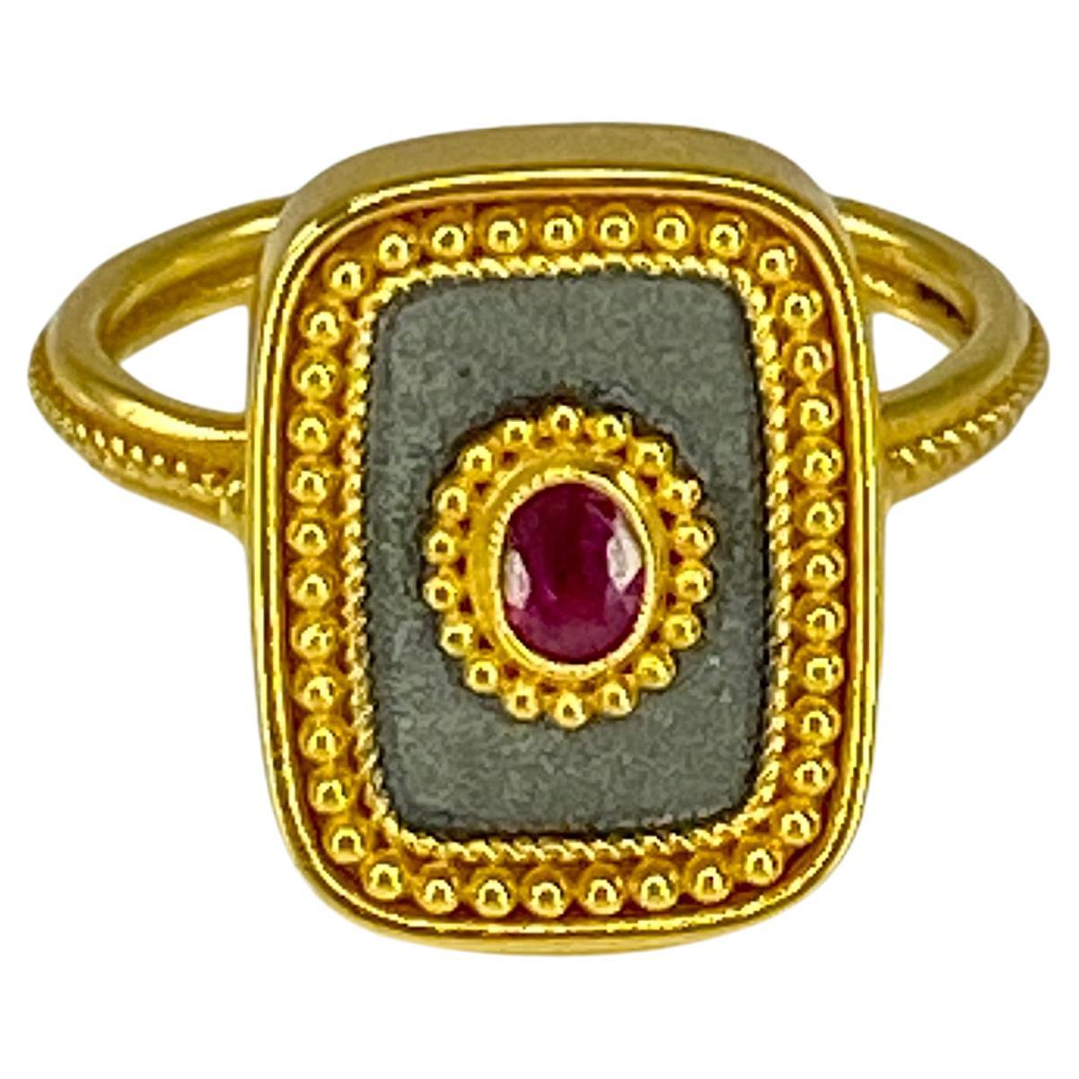 This S.Georgios designer ring is handmade from solid 18 Karat Yellow Gold and is microscopically decorated with Byzantine-style granulation work creating a stunning art piece. This beautiful long ring features an elegant center oval-cut natural Ruby