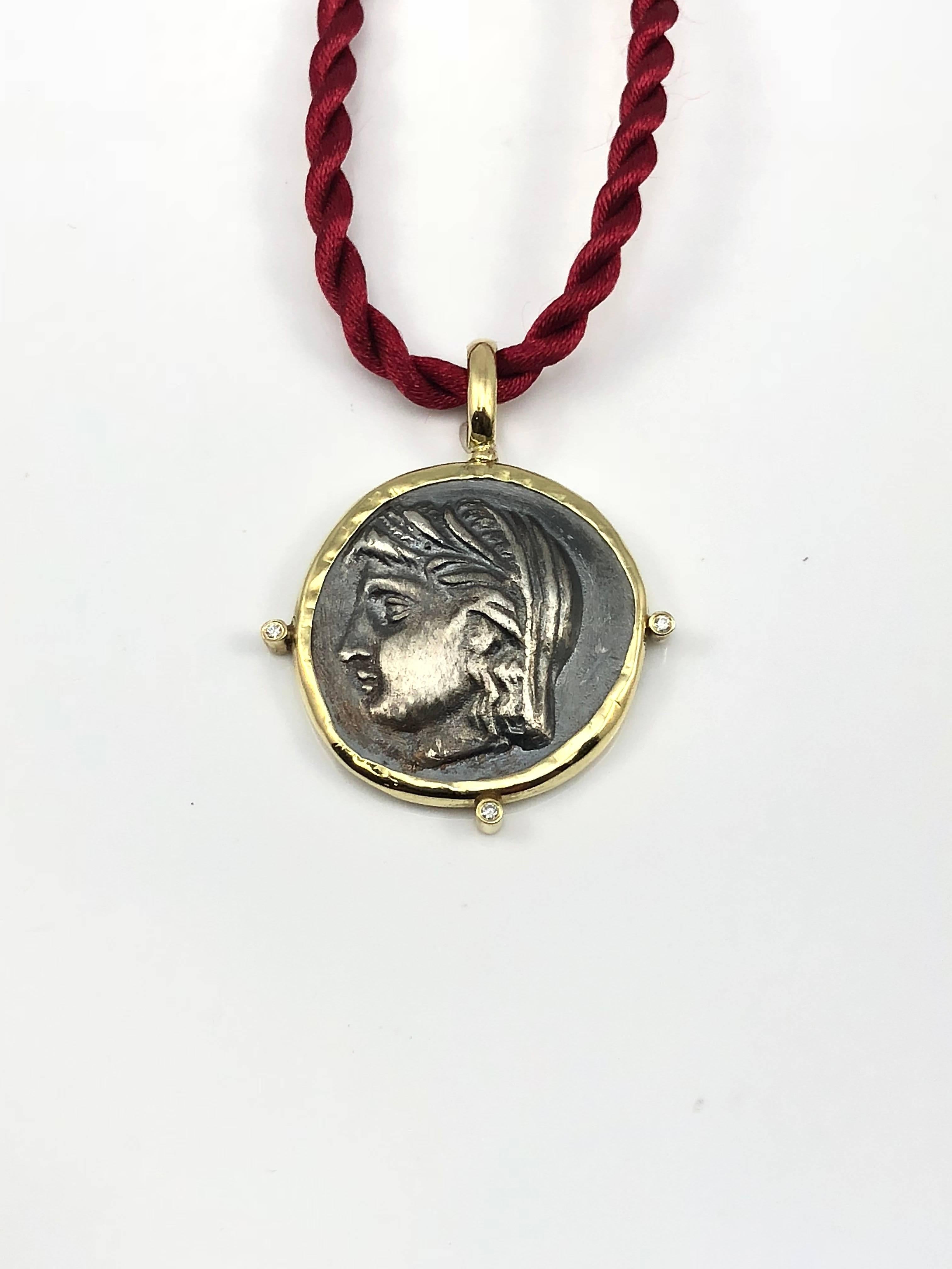 S.Georgios designer 18 Karat Yellow Gold handmade Coin Pendant Necklace featuring 6 Brilliant cut Diamonds (3 on the front side and 3 on the backside) total weight of 0.06 Carat and a replica of an Ancient Greek Coin of Dimitra in Silver 925. The