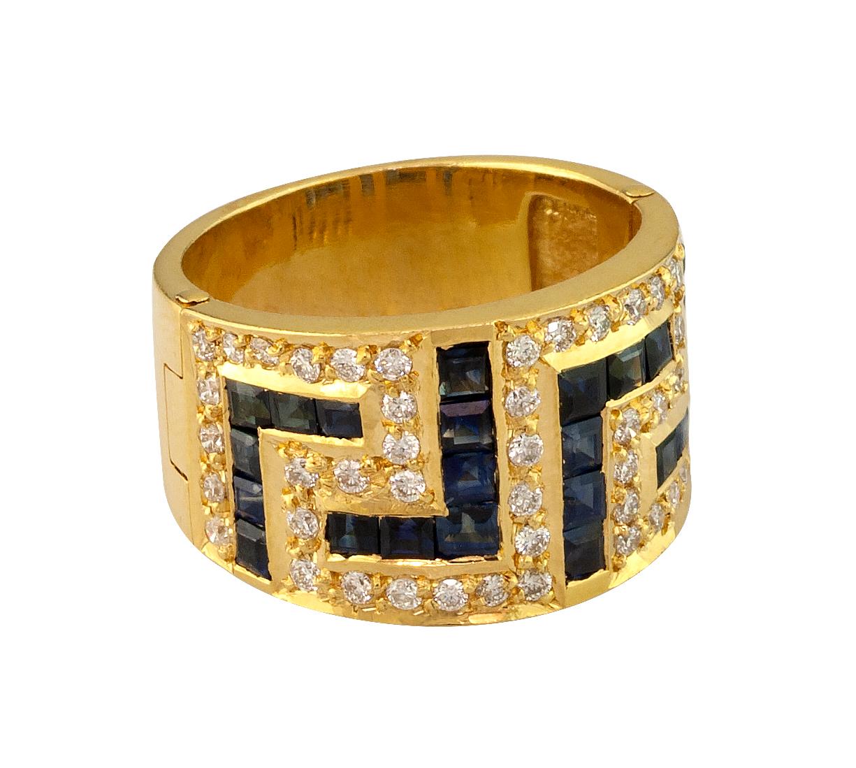 S.Georgios designer 18 Karat Yellow Gold Ring featuring the Greek Key design symbolizing eternity. It has 48 Brilliant Cut White Diamonds total weight of 0.65 Carat and 24 Princess cut  Sapphires total weight of 2.40 Carat. The quality of the stones
