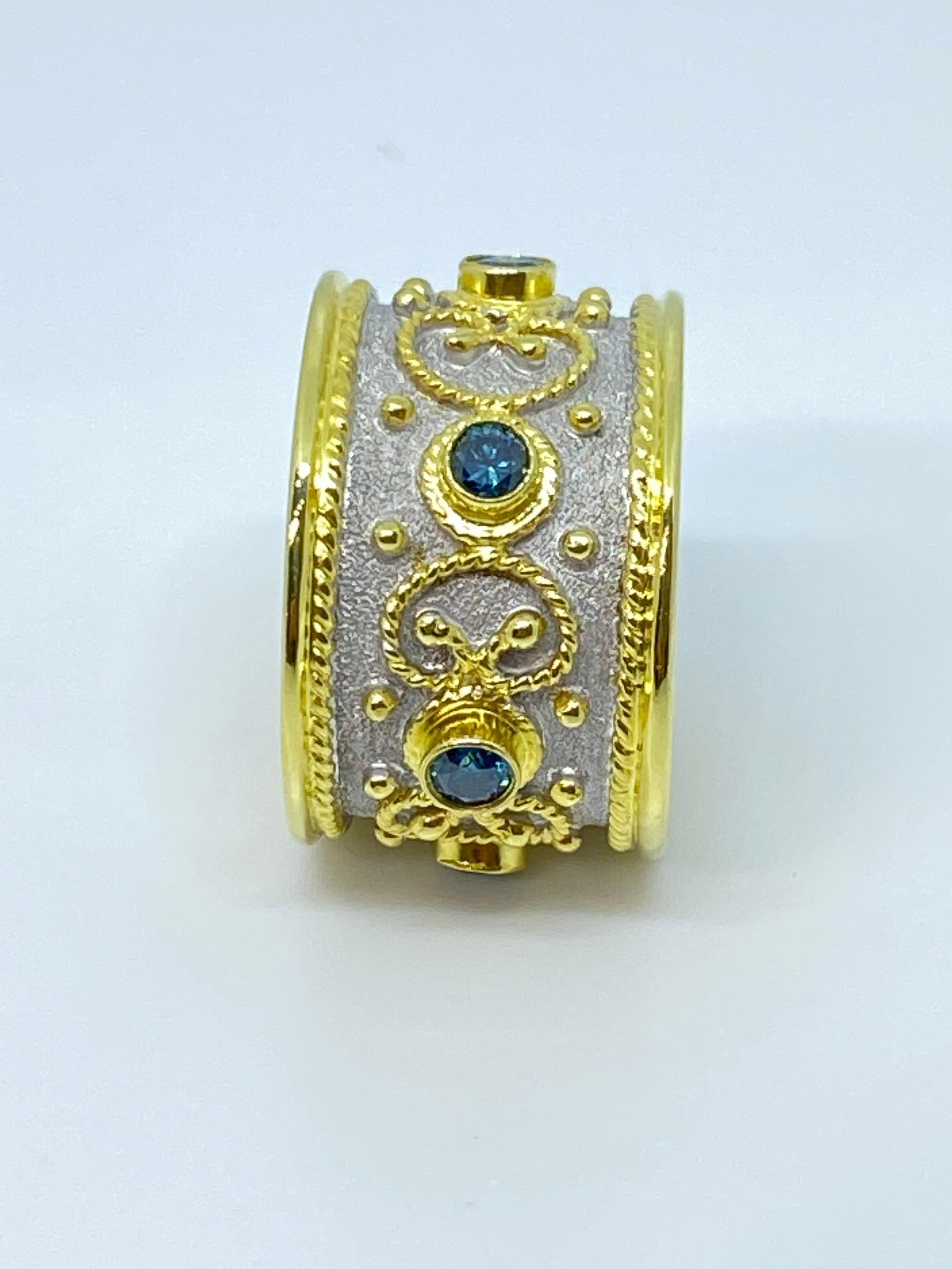S.Georgios designer Diamond Band Ring is handmade from solid 18 Karat Yellow Gold. The beautiful Yellow Gold Band ring is microscopically decorated all the way around with Yellow Gold bead and wire granulation -with the Omega, the last letter of the
