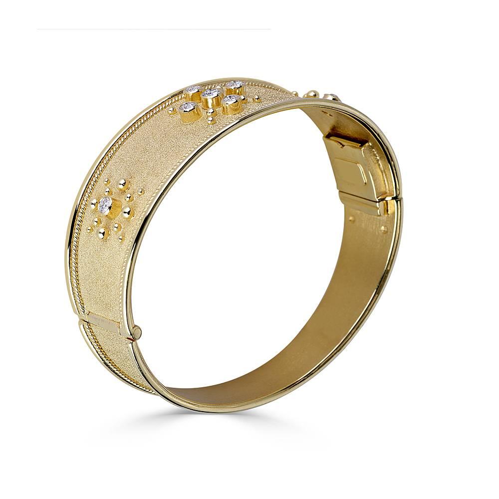 S.Georgios designer bangle bracelet in solid 18 Carat Yellow Gold all handmade with the Byzantine workmanship.  Bracelet is decorated with 22 Karat granulation decors all the way around and velvet effect background. The bangle is featuring 7 White