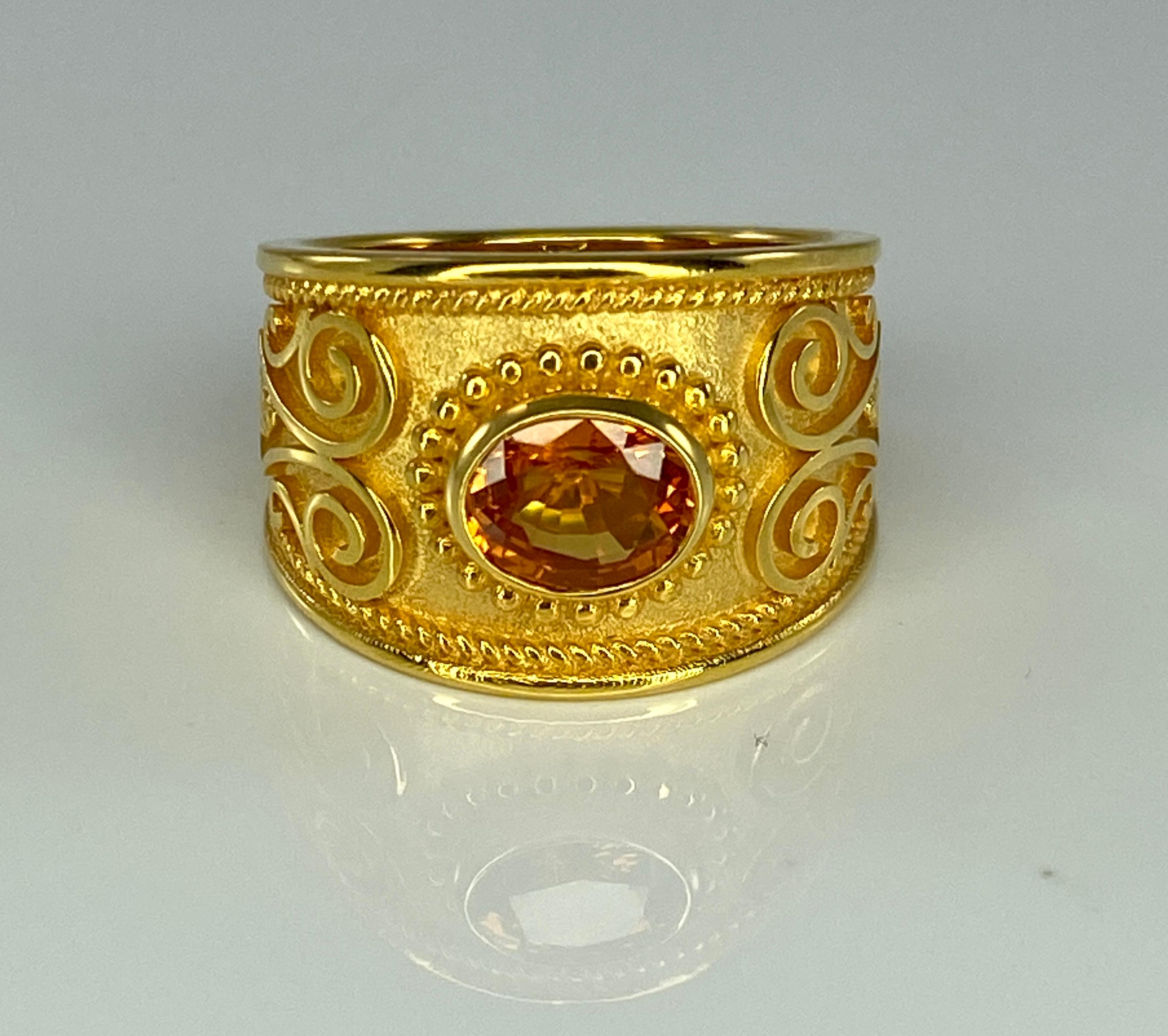 Presenting S.Georgios designer 18 Karat Solid Yellow Gold Ring all handmade with the Byzantine Style workmanship and a unique velvet background decorated with natural oval cut 1.52 Carat Orange Sapphire. All the granulated decorations of this ring
