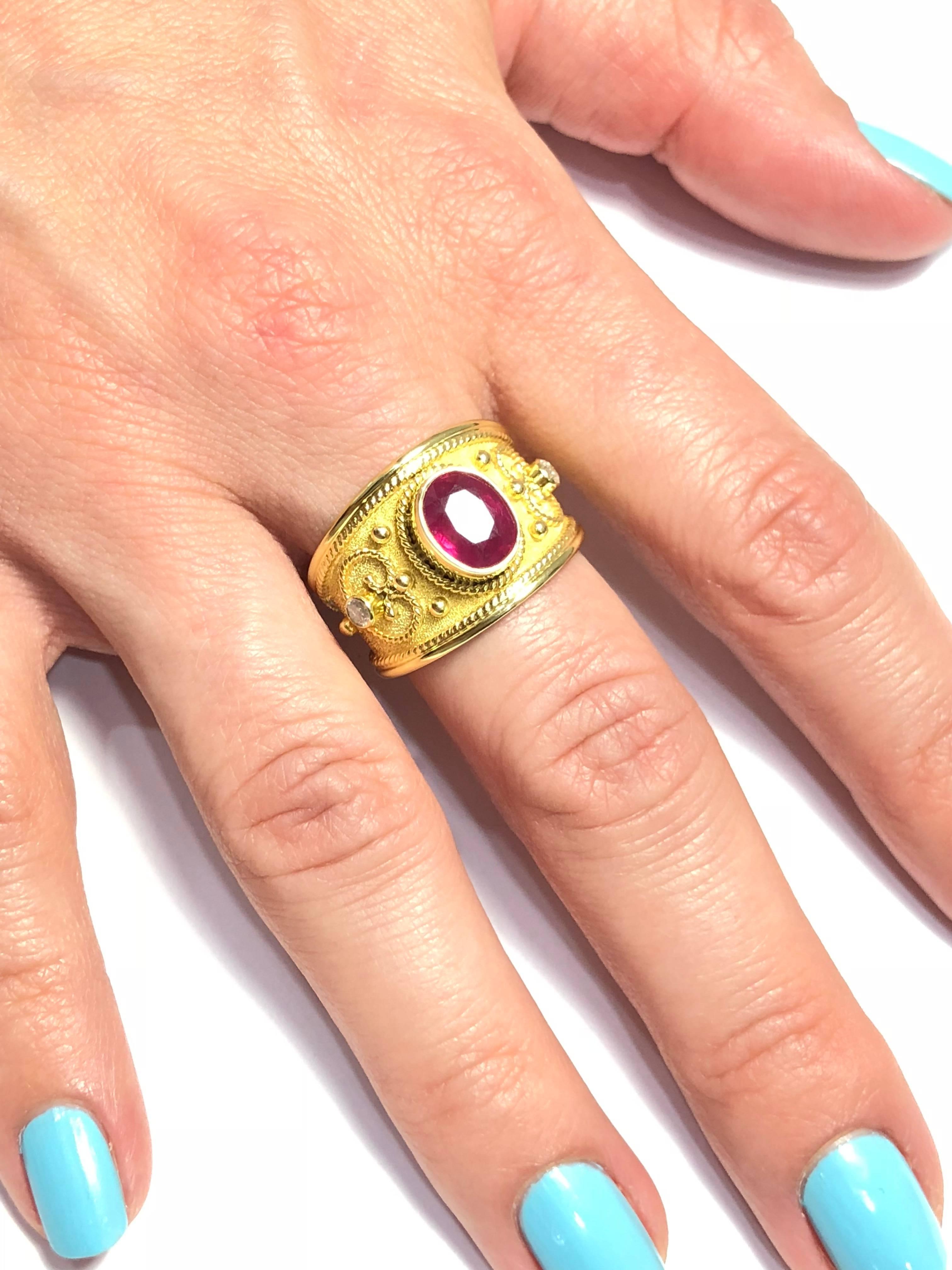 S.Georgios designer 18 Karat Solid Yellow Gold Ring all handmade with the Byzantine Style workmanship and a unique velvet background. The ring features a 2.58 Carat Natural Ruby which has been heated to enhance the color density, 2 Brilliant cut
