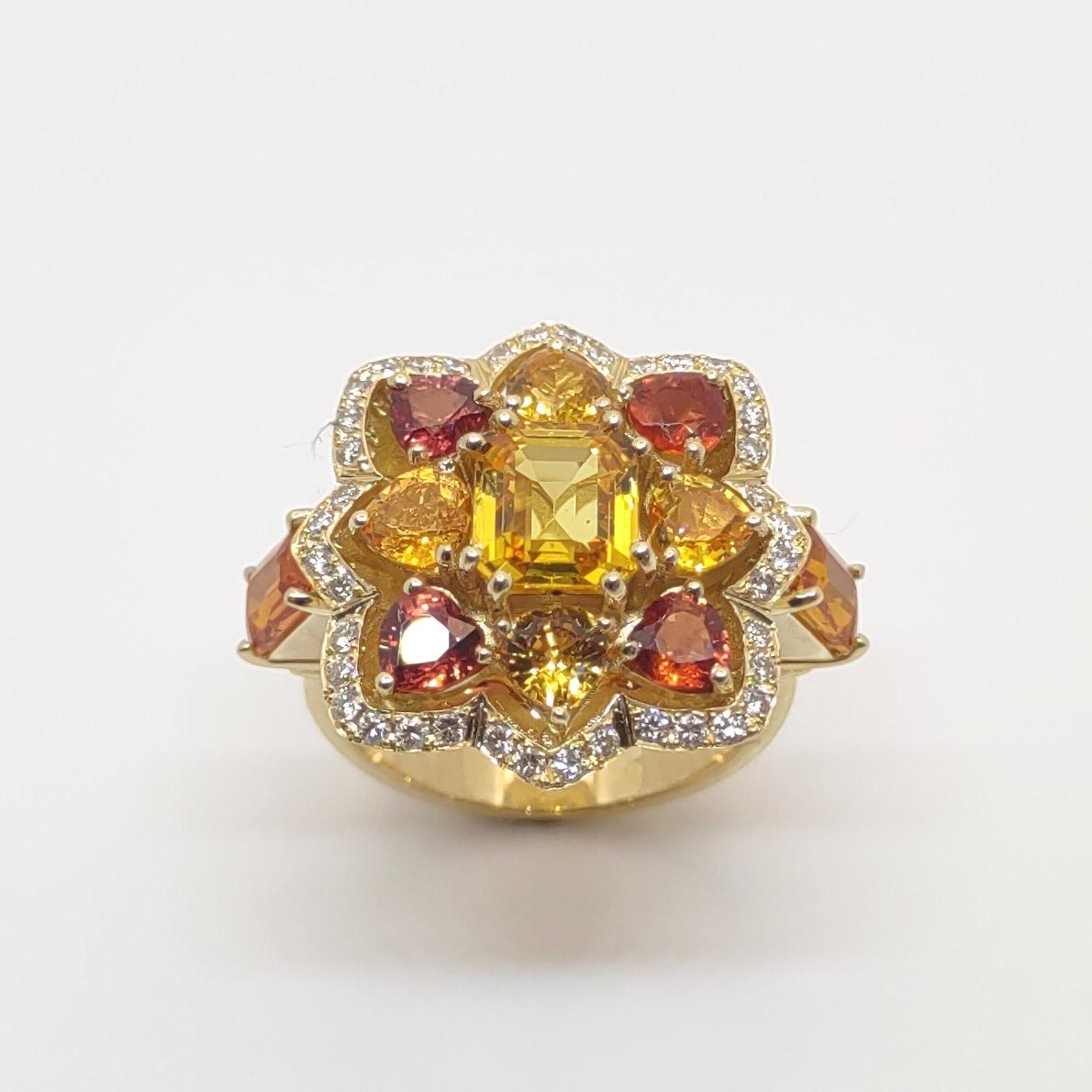Presenting S.Georgios designer Ring all hand-made in 18 Karat Yellow Gold. This stunning ring features Multicolor Yellow and Orange Sapphires with a total weight of 5.51 Carats. The center baguette-cut yellow sapphire is surrounded by heart-shaped