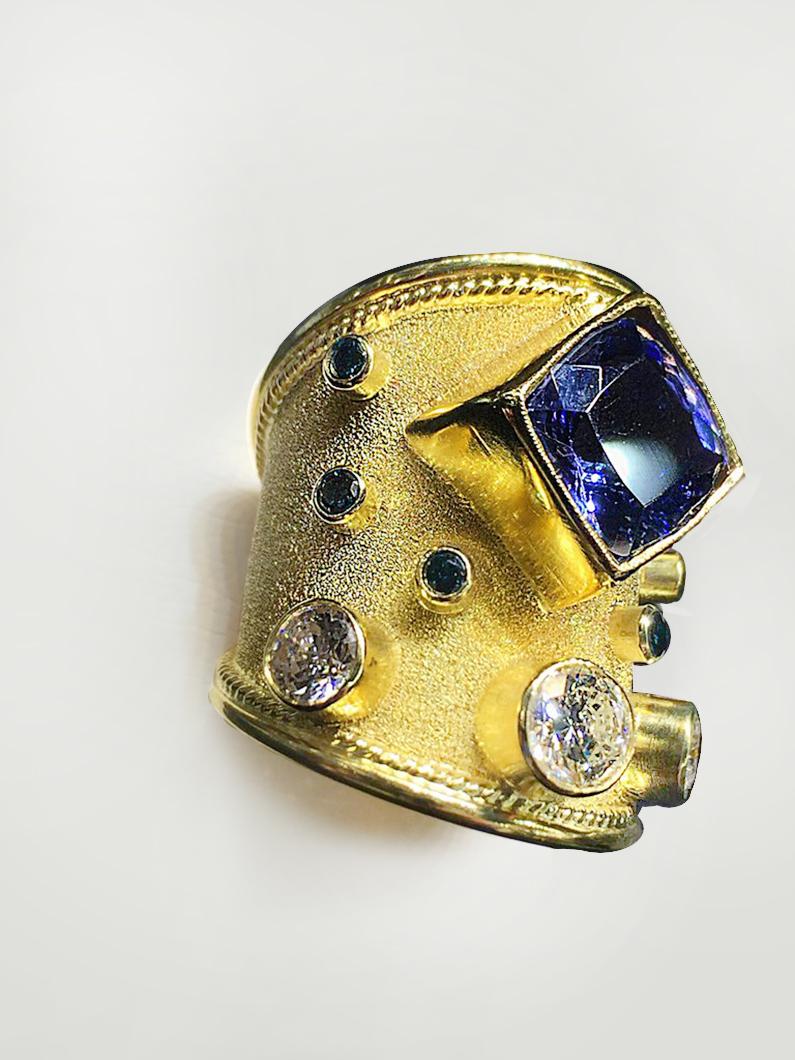 S.Georgios designer 18 Karat Solid Yellow Gold Ring all handmade with the Byzantine granulation workmanship and a unique velvet background all custom-made. The gorgeous ring has 1 Center Cushion Cut Tanzanite total weight of 4.45 Carats and 3