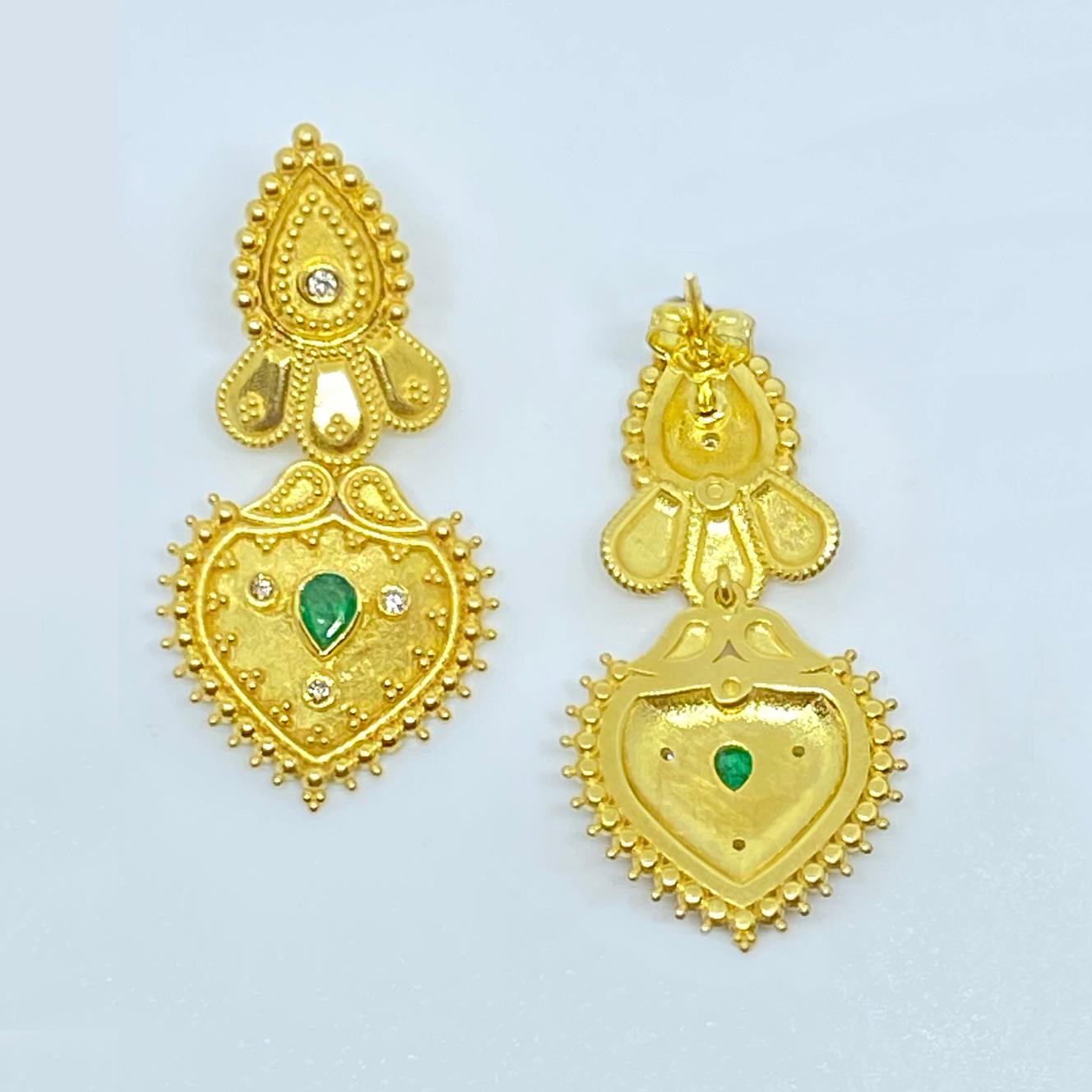 These S.Georgios designer earrings are hand made from 18 Karat Yellow Gold and are decorated with Byzantine-era style, granulation workmanship and feature Brilliant cut Diamonds total weight of 0.26 Carats and 2 natural emeralds total weight of 0.63