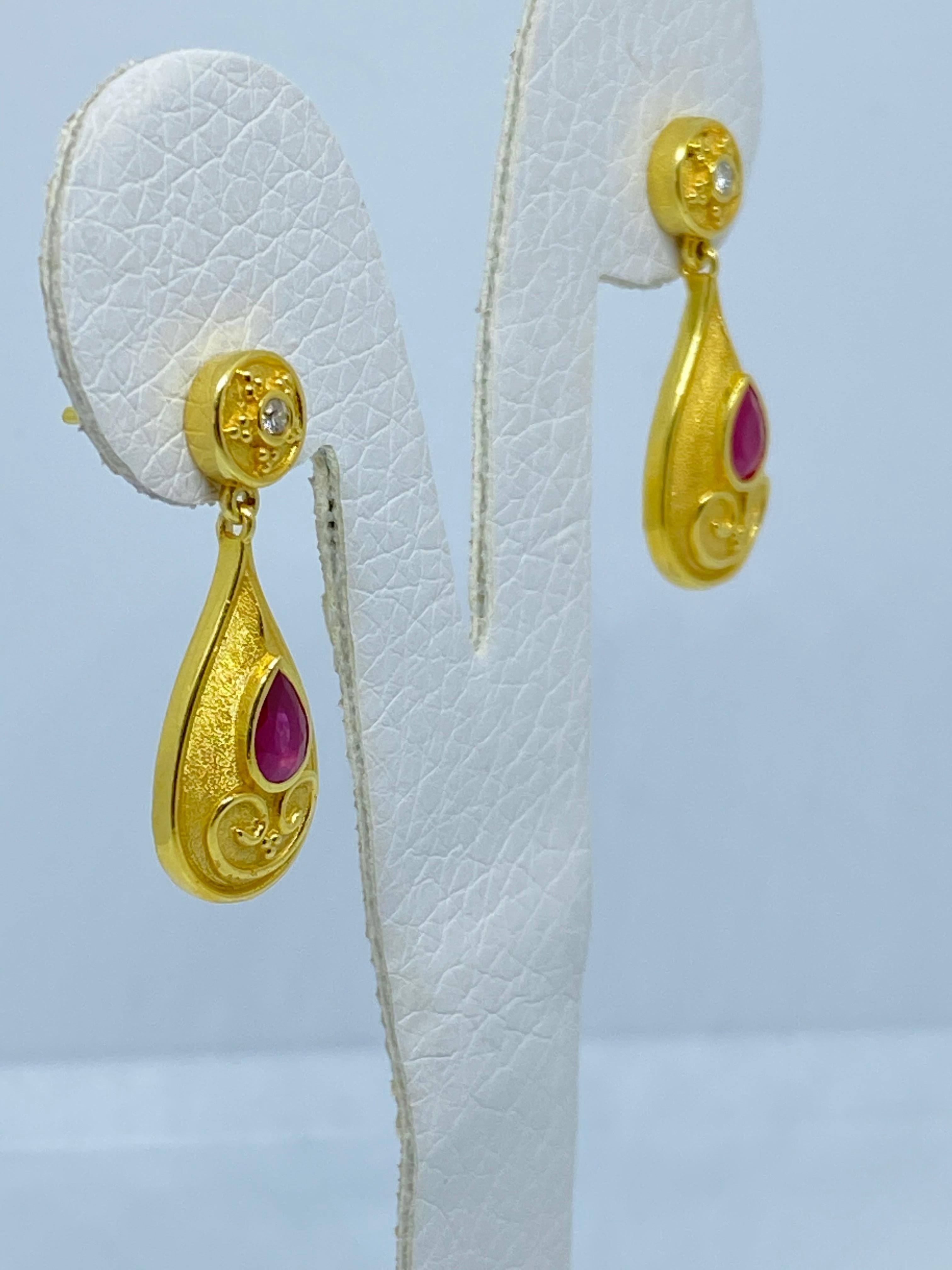 These S.Georgios designer earrings are hand made from 18 Karat Yellow Gold and decorated with Byzantine-era style granulation workmanship. These beautiful earrings feature 2 Brilliant cut Diamonds total weight of 0.10 Carats, complemented with 2