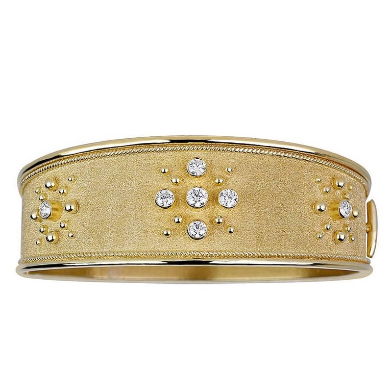 S.Georgios designer bangle bracelet in solid 18 Karat Yellow Gold all handmade with the Byzantine workmanship. The beautiful bracelet is decorated with 22 Karat granulation decors all the way around and a unique velvet look on the background. The
