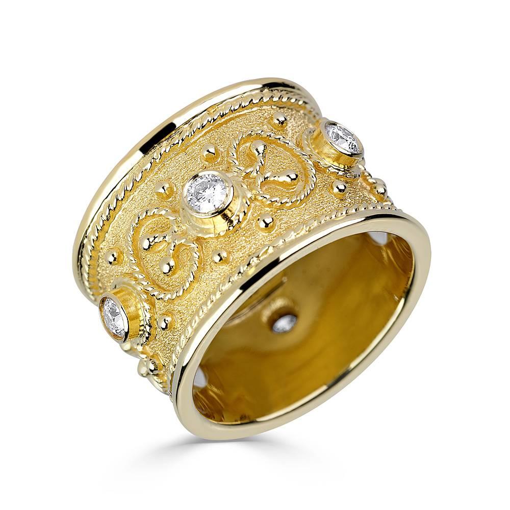 This S.Georgios designer band ring is handmade from solid 18 Karat Yellow Gold. The gorgeous ring is microscopically decorated all the way around with gold beads and wires shaped like the last letter of the Greek Alphabet - Omega, which symbolizes
