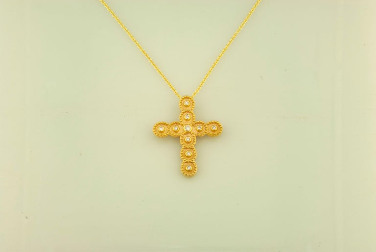 This S.Georgios designer 18 Karat Yellow Gold cross pendant necklace and chain is handmade with microscopically decorated Byzantine-style granulation work and is finished with a unique velvet background look. This beautiful cross pendant necklace