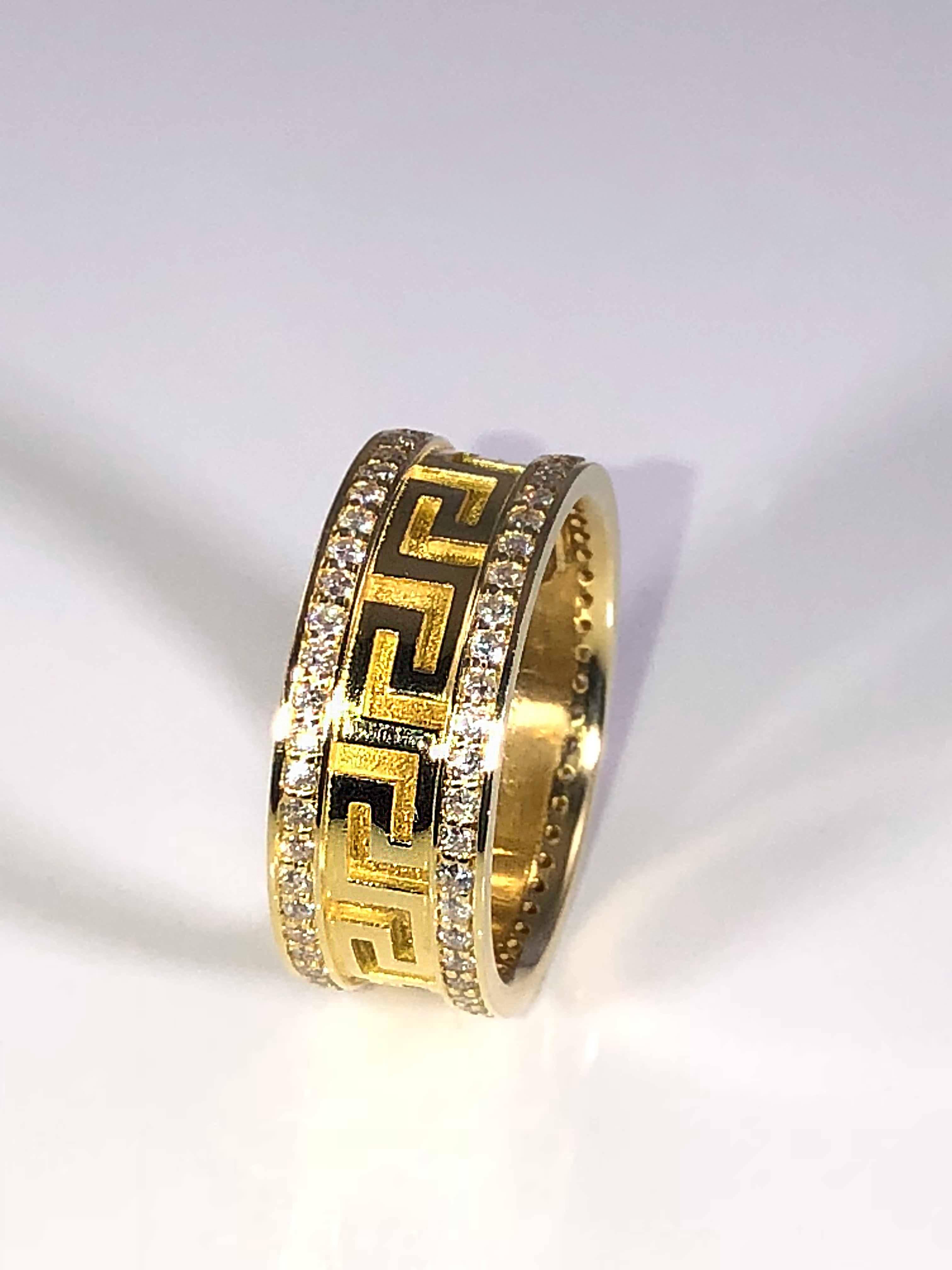 S.Georgios designer solid yellow gold 18 karat band is all handmade and has the design of the Greek Key all the way around without a beginning or an end. The design symbolizes the key to eternal life.
The ring has a unique velvet look on the
