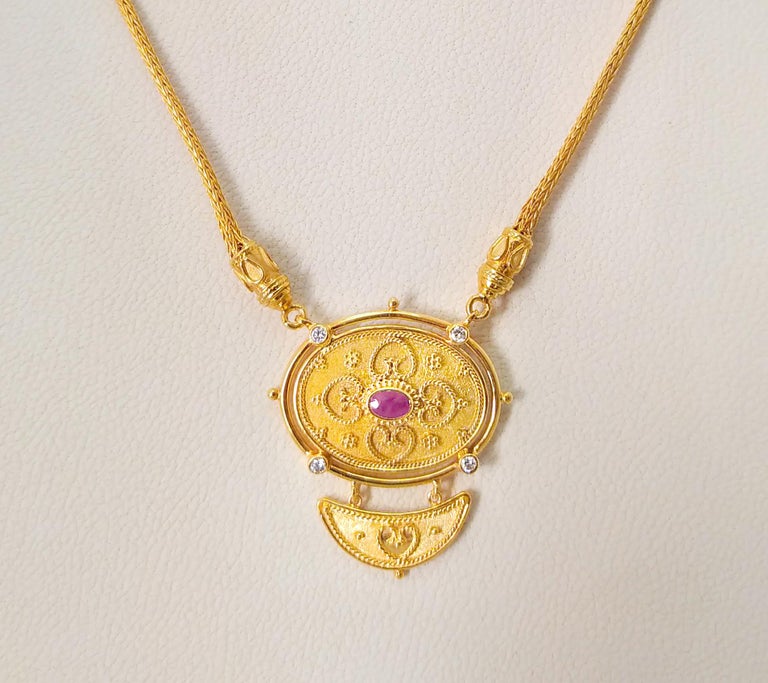 This S.Georgios 18 Karat Yellow Gold Drop Pendant Necklace is microscopically decorated with Byzantine-style beads and wires -granulation workmanship and is finished with a unique velvet background look. This gorgeous Necklace showcases a stunning