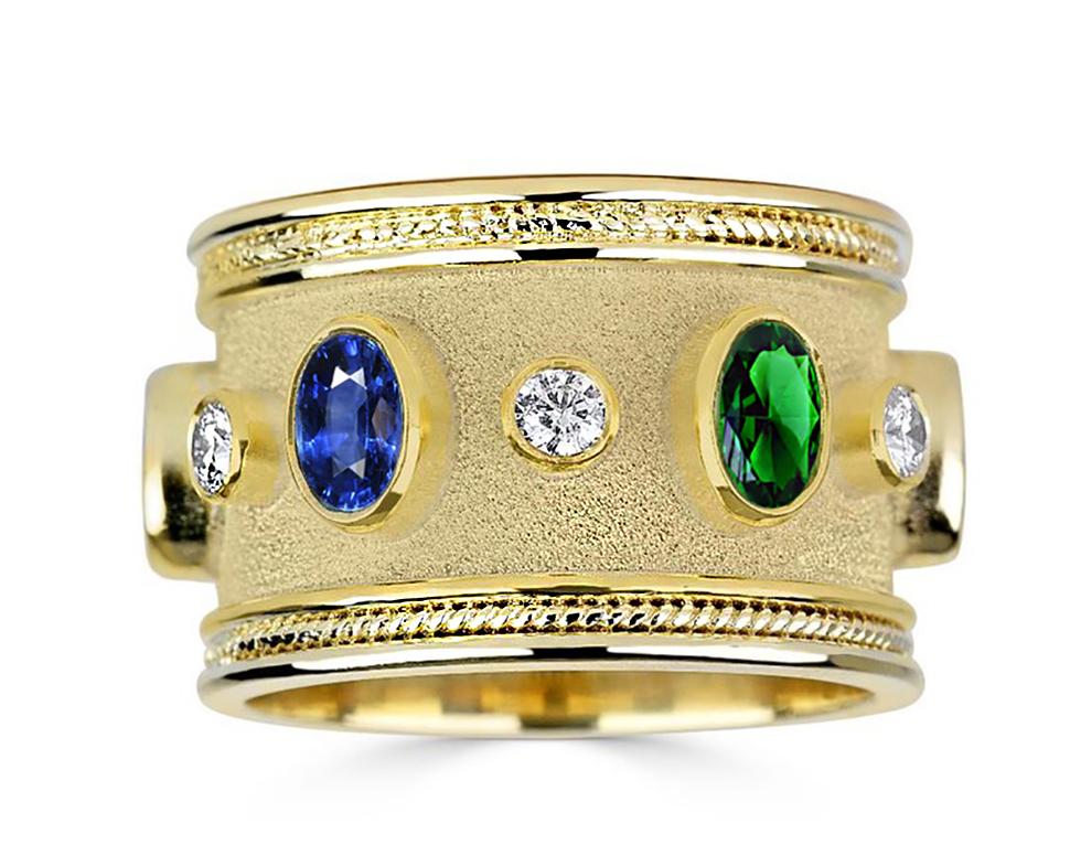 S.Georgios designer 18 Karat Solid Yellow Gold Ring all handmade with Byzantine workmanship and a unique velvet background. The gorgeous ring features 6 Brilliant cuts White Diamonds with a total weight of 0.56 Carat, also 2 oval cut Sapphires total