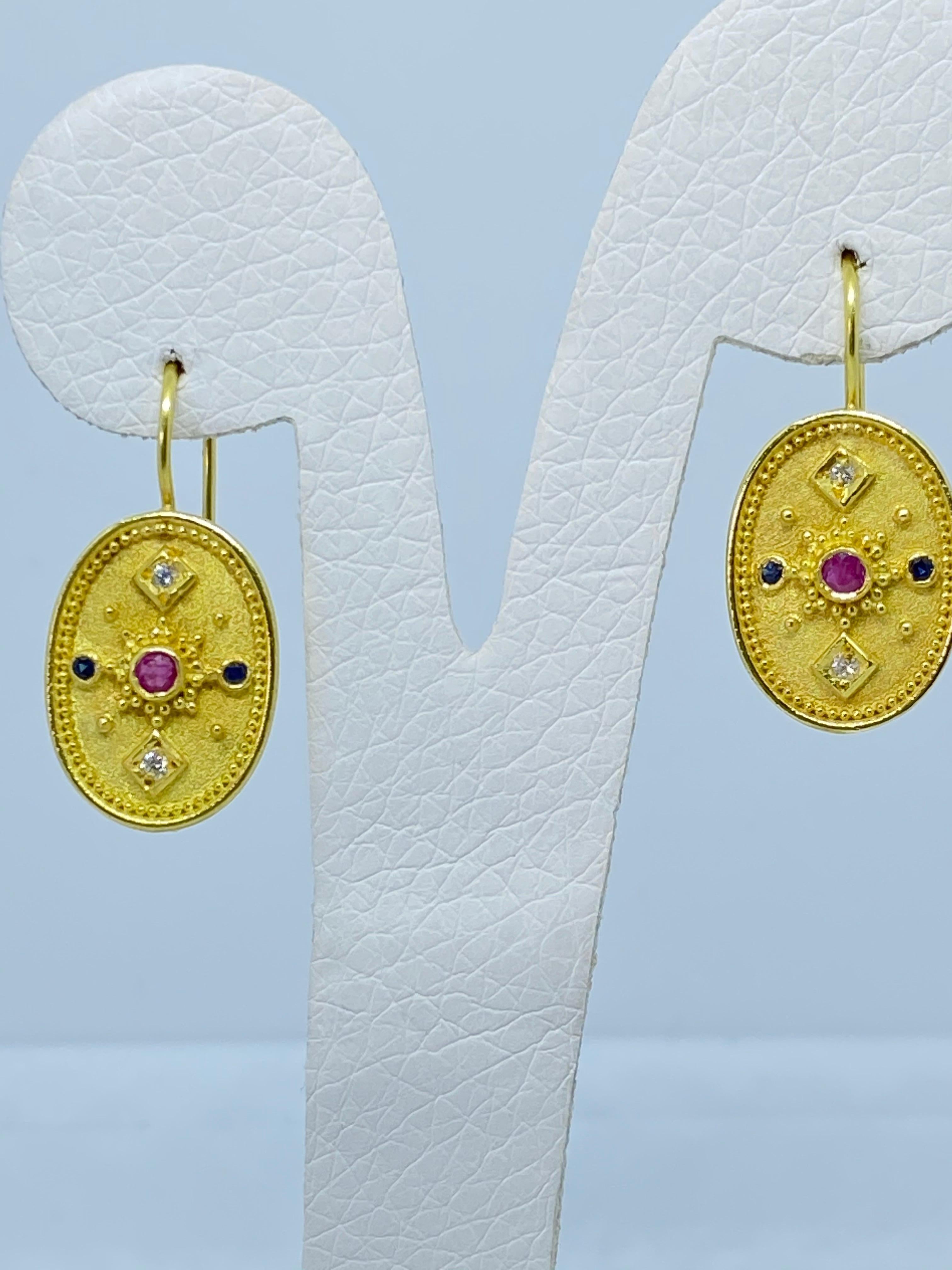 These S.Georgios designer earrings are hand made from 18 Karat Yellow Gold and decorated with Byzantine-era style granulation workmanship. These beautiful earrings feature 2 brilliant-cut Rubies with a total weight of 0.12 Carat surrounded by 4