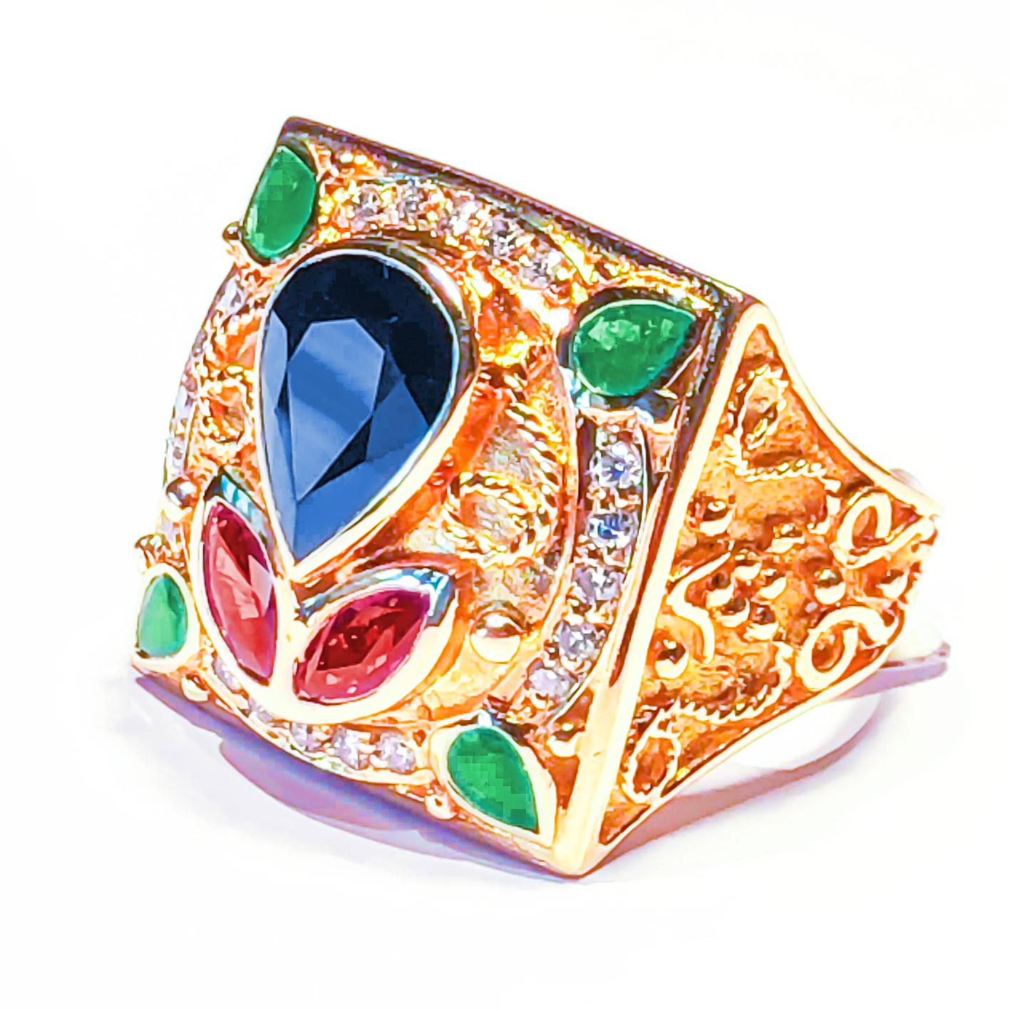 S.Georgios designer Ring is all handmade from solid 18 Karat Yellow Gold and is microscopically decorated with gold wires and beads, Granulated details contrast with Byzantine-style background finish. It features 1 Center pear shape Sapphire total