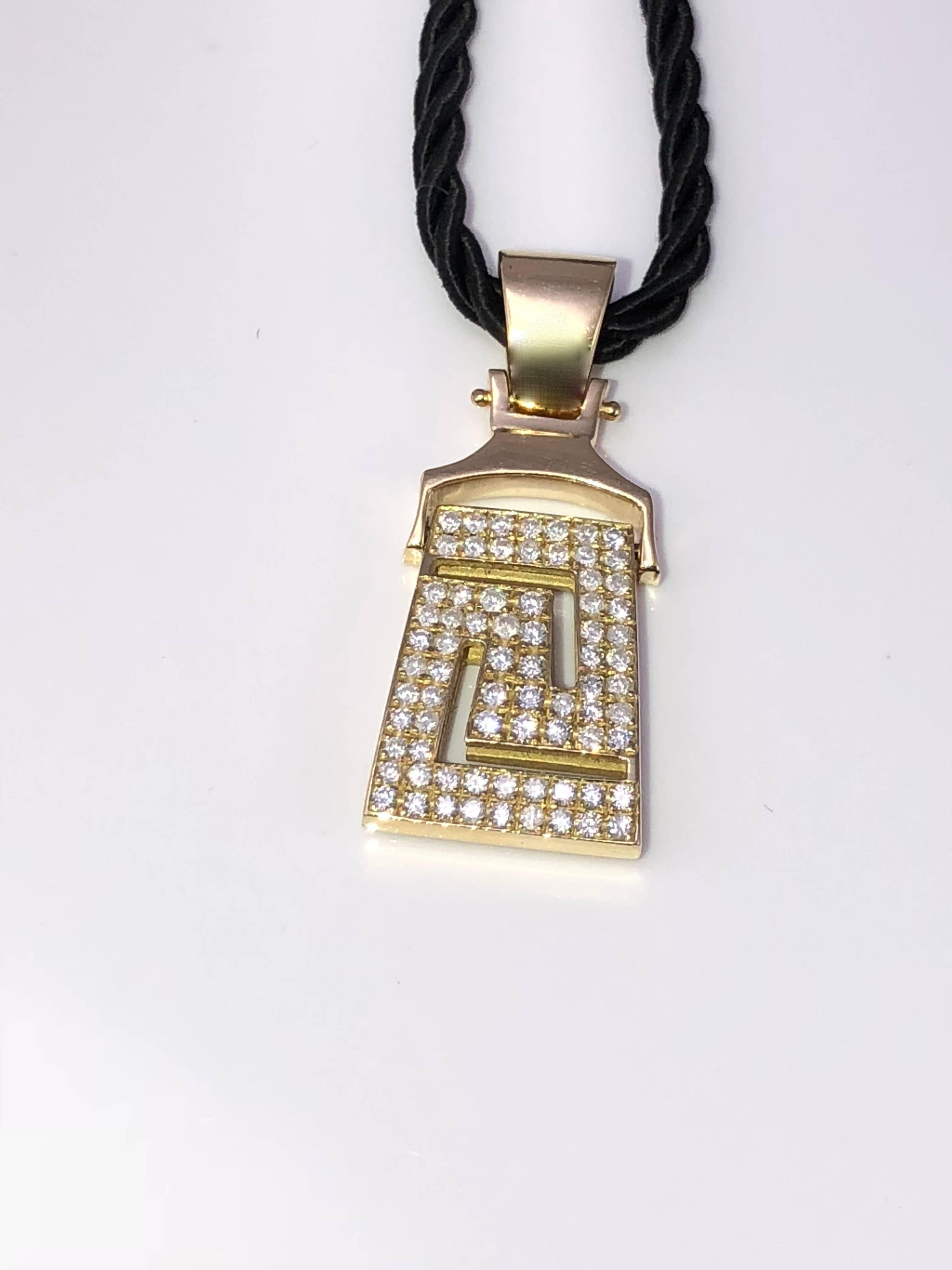 S.Georgios designer 18 Karat Yellow Gold Pendant Necklace with Diamonds shaping the Greek Key design symbolizing eternity. The stunning pendant features Brilliant Cut White Diamonds total weight of 1.04 Carat and comes with 18-inch silk rope.
It can