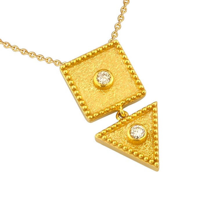 This S.Georgios designer pendant necklace is 18 Karat yellow gold and microscopically decorated with hand-made bead granulation workmanship, and finished with a unique velvet background look. This beautiful geometric necklace feature 2 brilliant-cut
