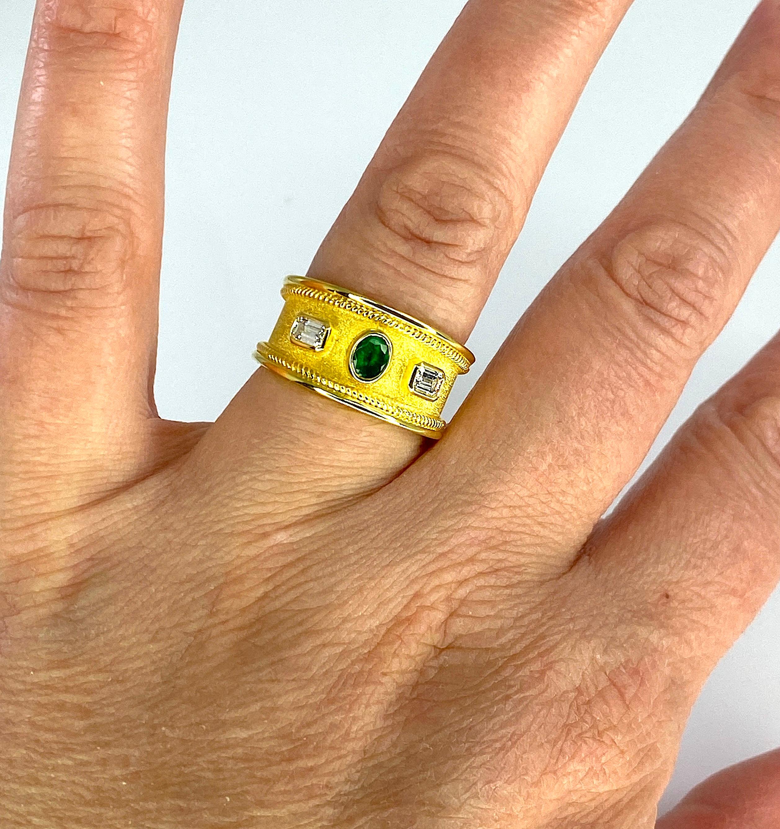 Georgios Collections presents S.Georgios designer Ring in 18 Karat Yello Gold decorated with a Byzantine velvet background and twisted wires around the edges. The center of the ring features a beautiful 0.27 Carat oval cut Emerald accompanied by two
