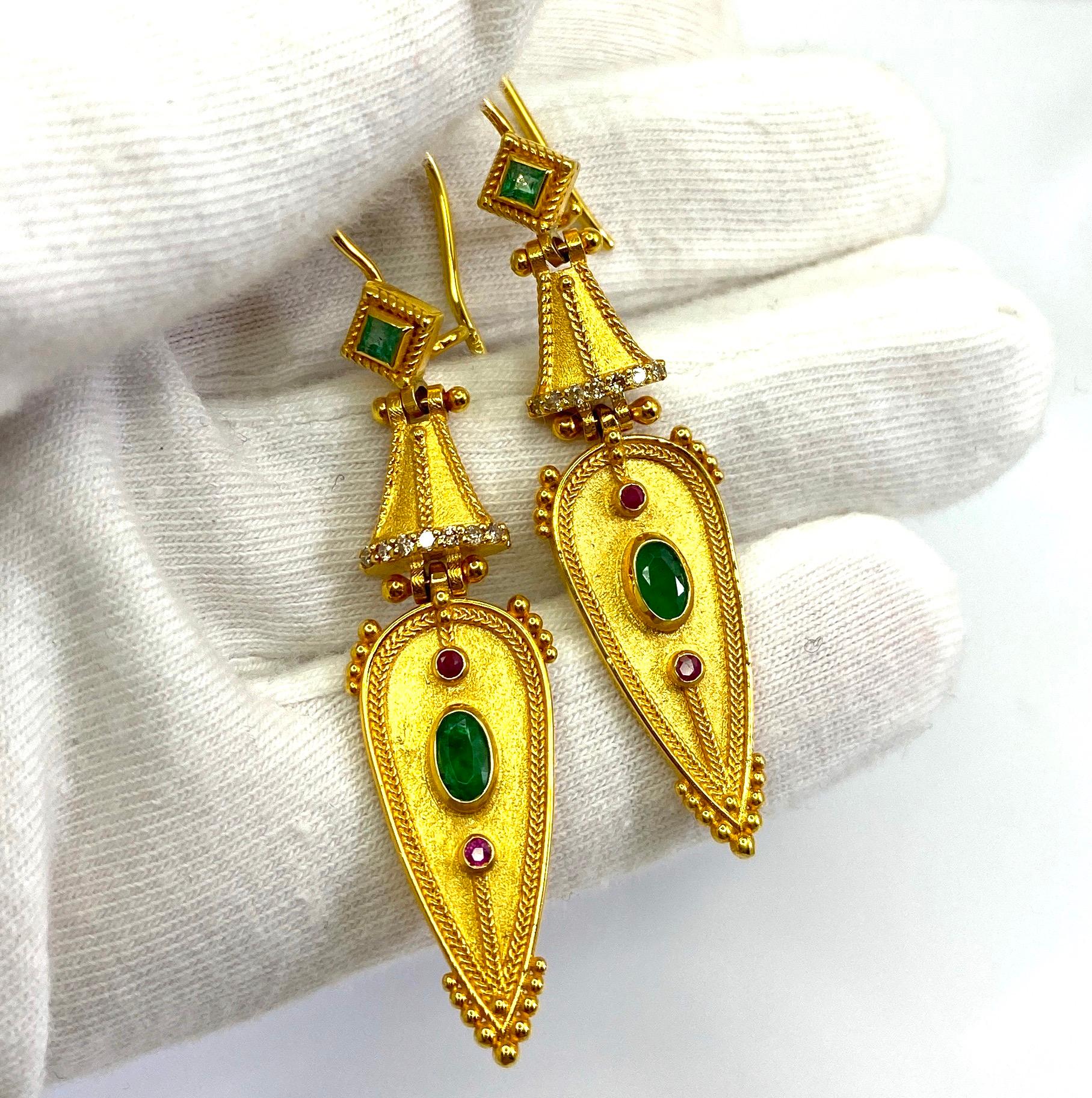 These S.Georgios designers Byzantine-era style 18 Karat Yellow Gold earrings are hand-made with granulation workmanship done microscopically and are finished with a unique velvet background. 
This gorgeous pair of earrings features 2 oval cut and 2