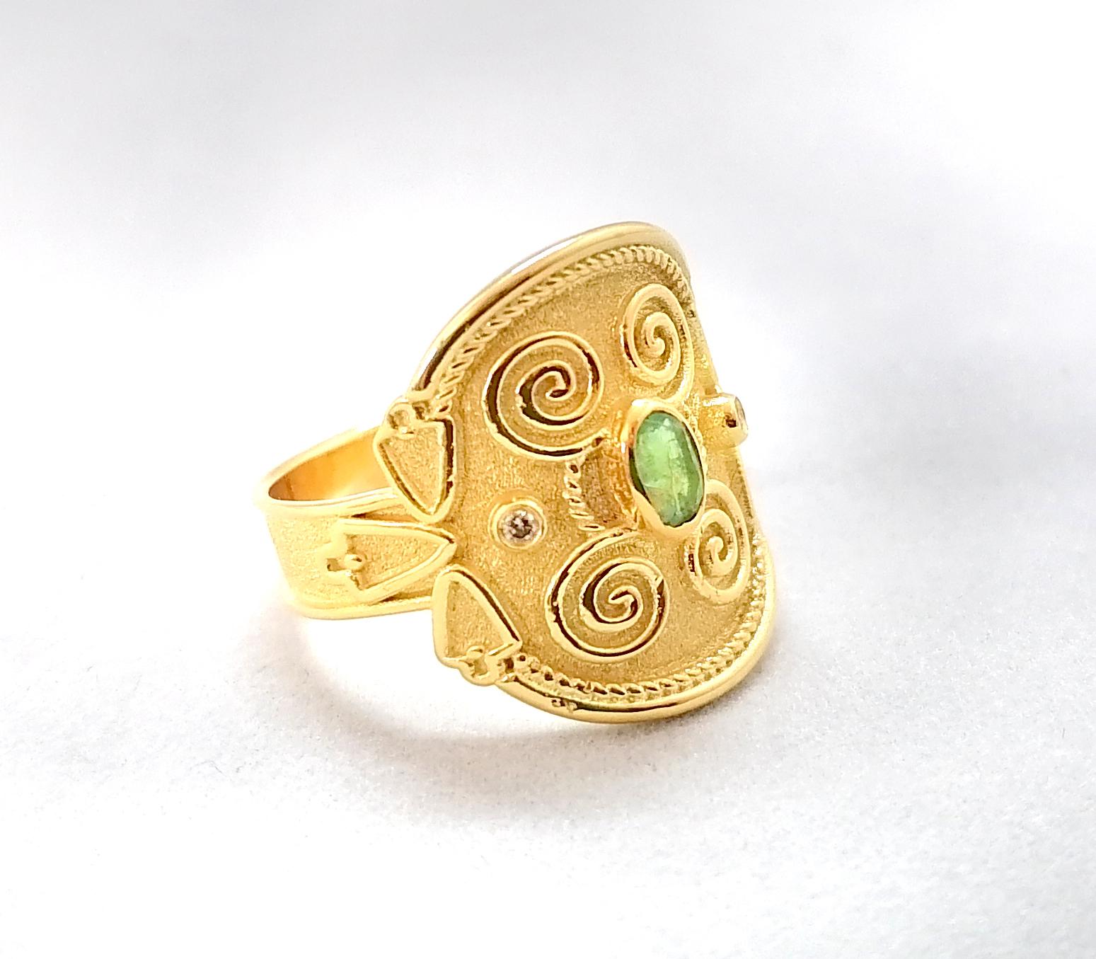 This S.Georgios unique designer Band Ring is 18 Karat Yellow Gold and all handmade with Byzantine bead granulation and a unique velvet background finished. This gorgeous band ring features an Oval cut natural Emerald total weight of 0.26 Carat,