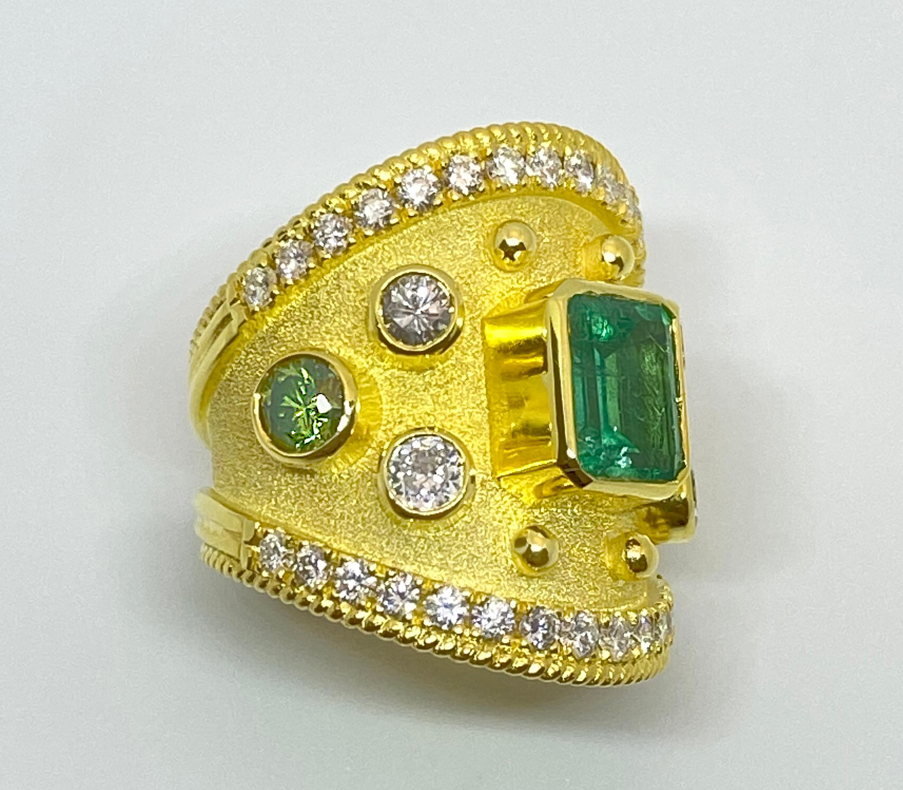 This S.Georgios designer 18 Karat Yellow Gold Band Ring is all handmade with a Byzantine Granulation Workmanship and a unique velvet background. This gorgeous band features in the center an Emerald cut natural Emerald total weight of 1.65 Carats, 4