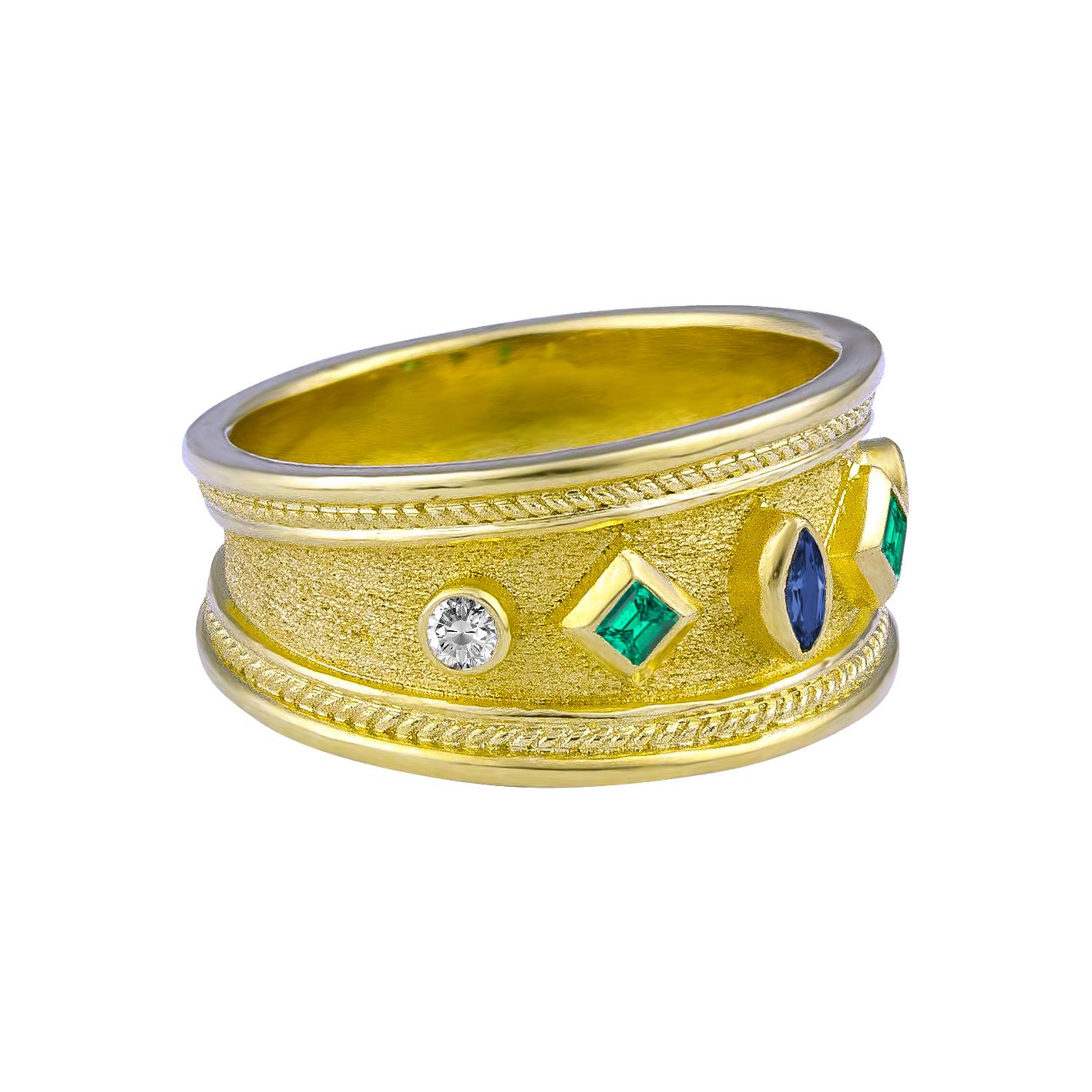 S.Georgios designer 18 Karat Solid Yellow Gold Band Ring is all handmade with Byzantine granulation workmanship and a unique velvet background. The gorgeous ring features a center 0.10 Carat Marquise Sapphire and on the sides, 2 natural Emeralds